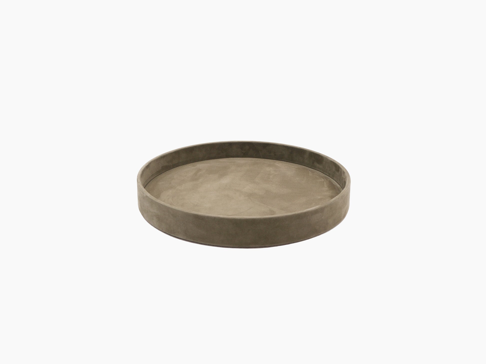 Round taupe valet tray holding a lidded ceramic pot and a glass container.