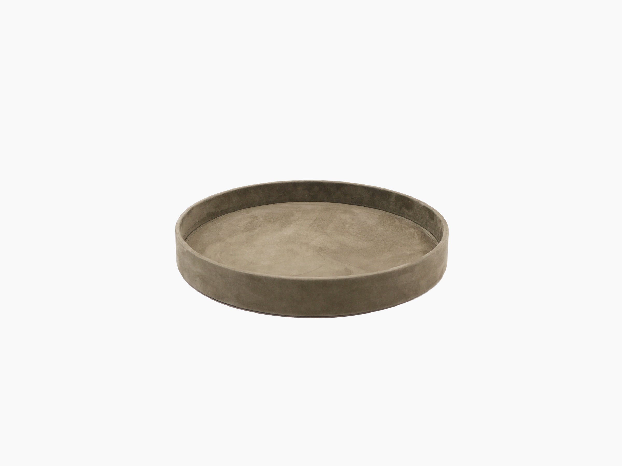Round taupe valet tray holding a lidded ceramic pot and a glass container.
