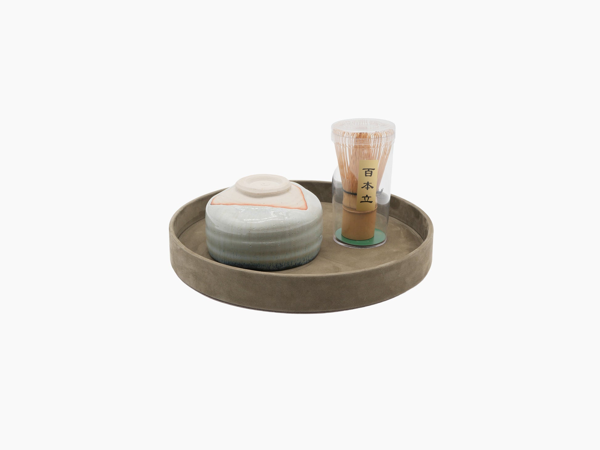 Dama Round Valet Tray shown with a ceramic jar and a tall glass container with a lid.