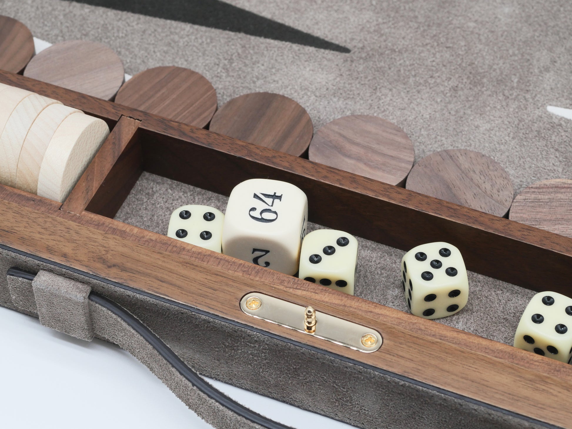 Open Bond backgammon case showing ivory dice and polished boxwood checkers in a suede-lined interior