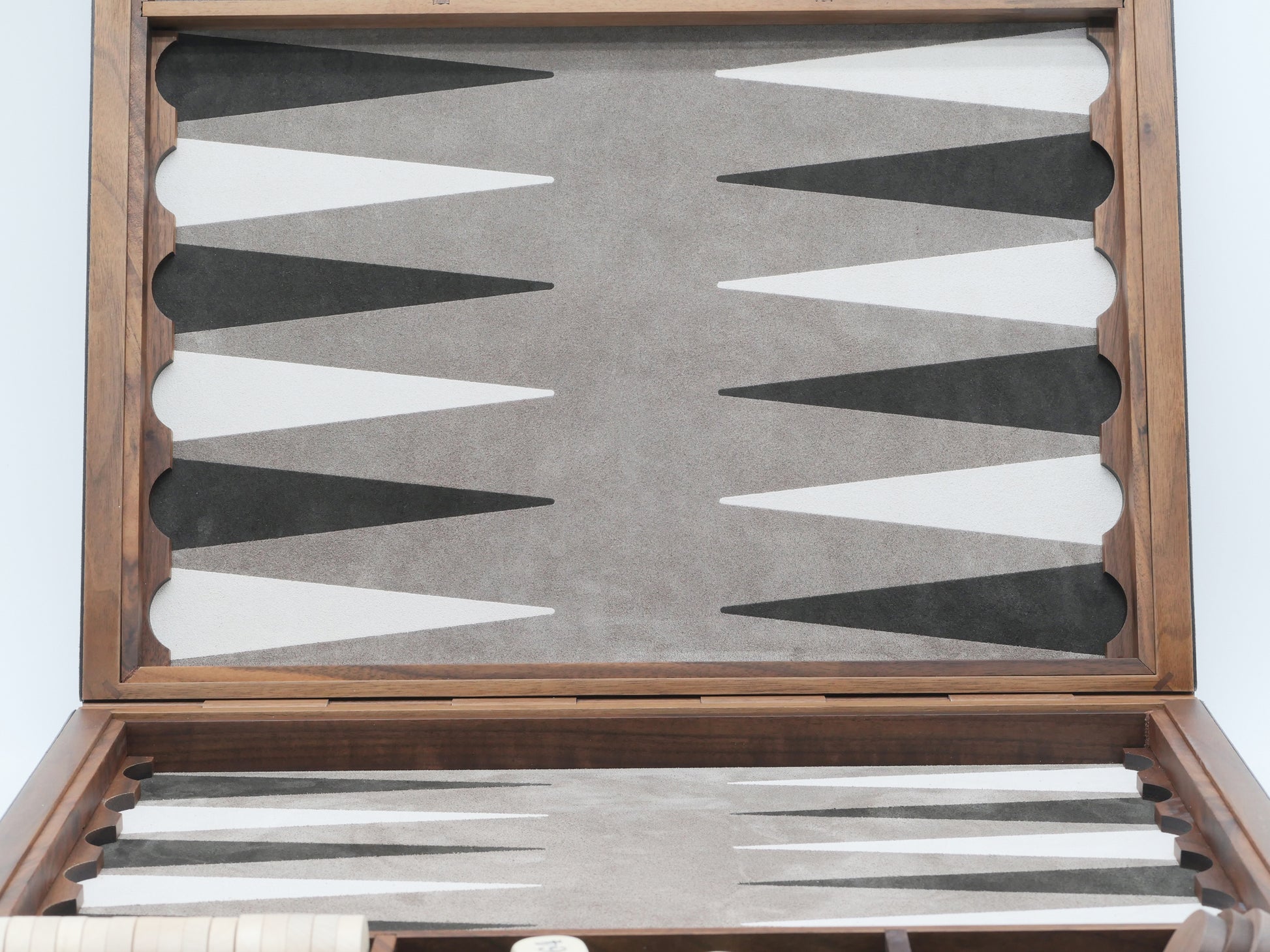 Bond Backgammon Case opened showing a leather inlaid backgammon board with light and dark points and a set of polished boxwood checkers inside