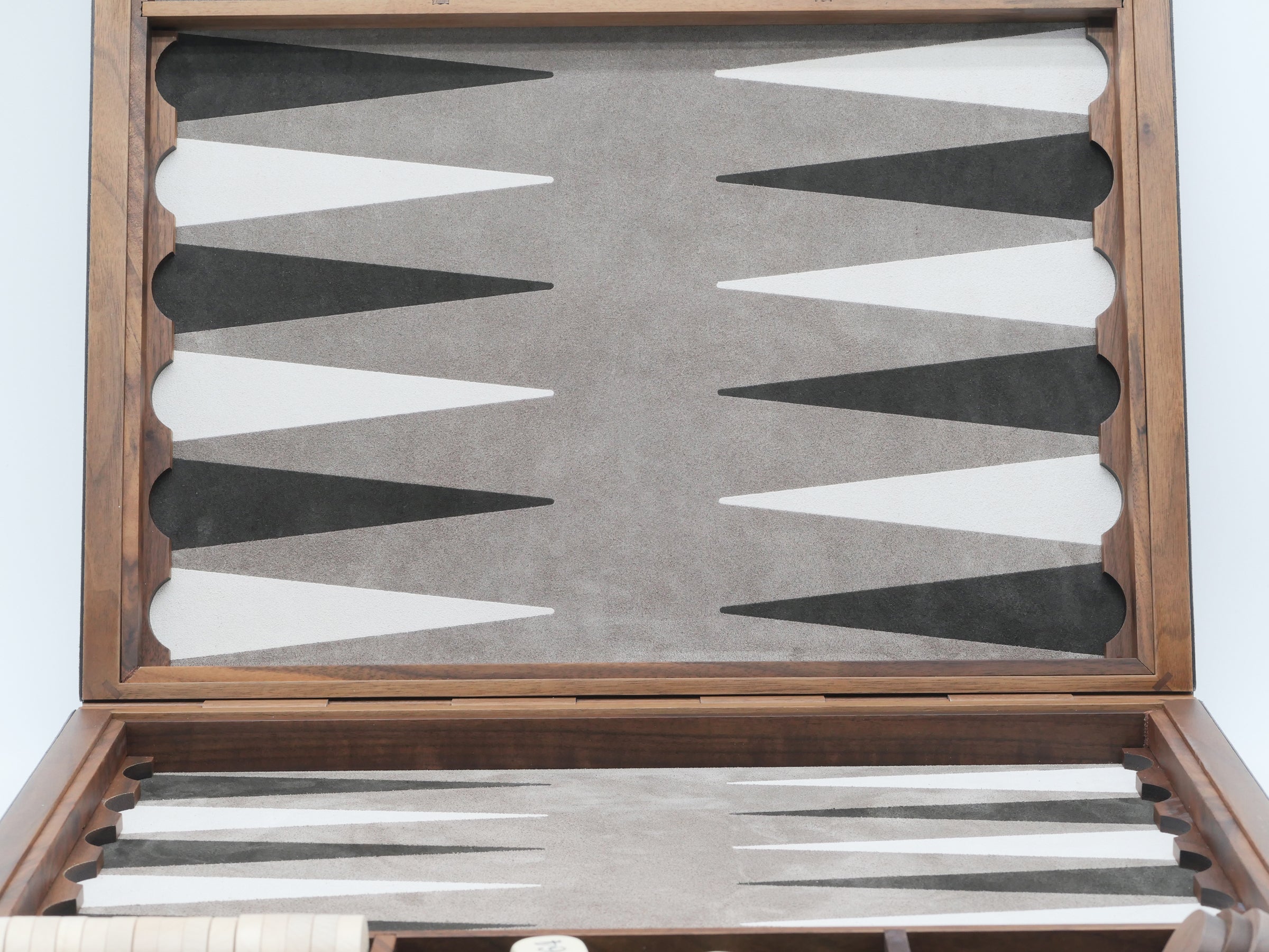 Bond Backgammon Case opened showing a leather inlaid backgammon board with light and dark points and a set of polished boxwood checkers inside