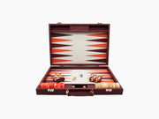 Open burgundy leather backgammon case with orange and burgundy triangular points and visible dice and leather cups