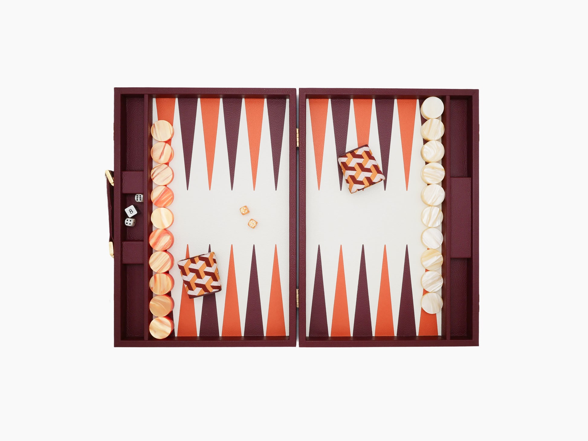 Two halves of a burgundy leather backgammon box opened to reveal orange and cream triangular points and checkers