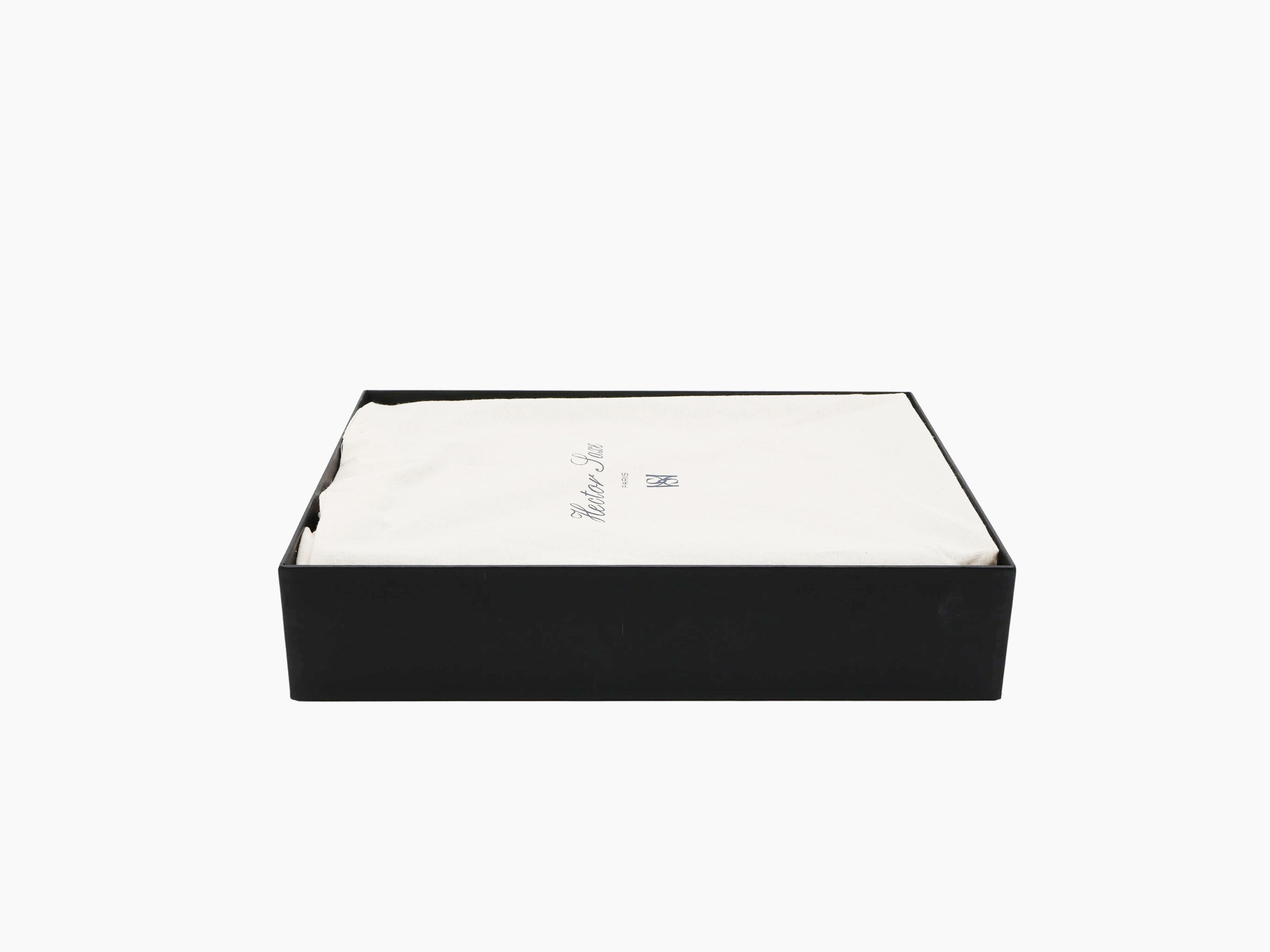 Open black rectangular gift box with white fabric lining, hinting at a patinable cognac backgammon set
