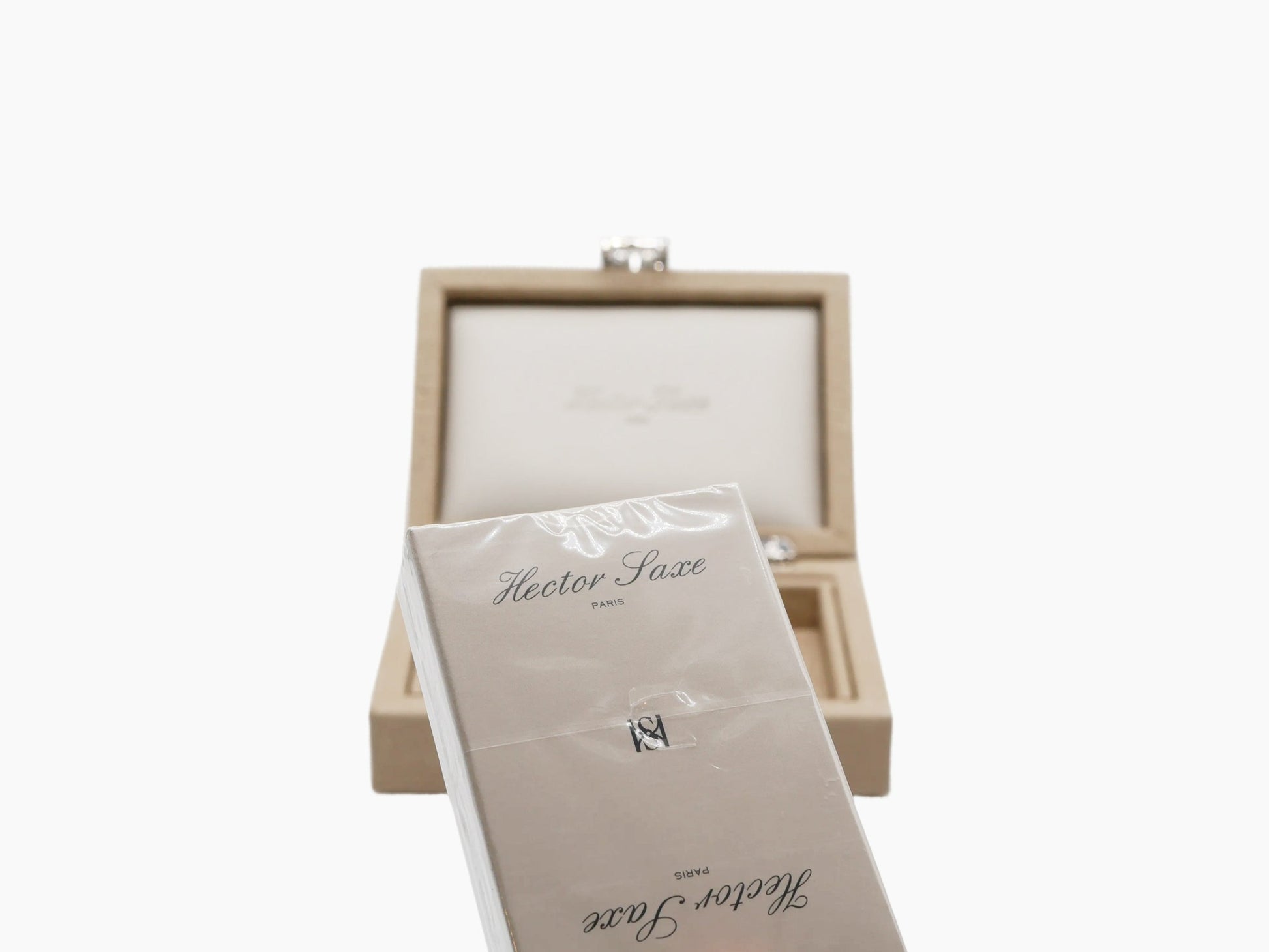 Two plastic-coated card decks displayed in a beige inner tray inside a black outer box.