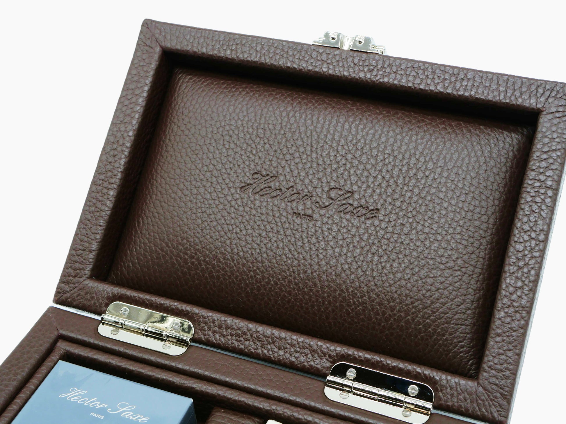 Close-up of the interior lid of the brown buffalo leather box showing embossed script.