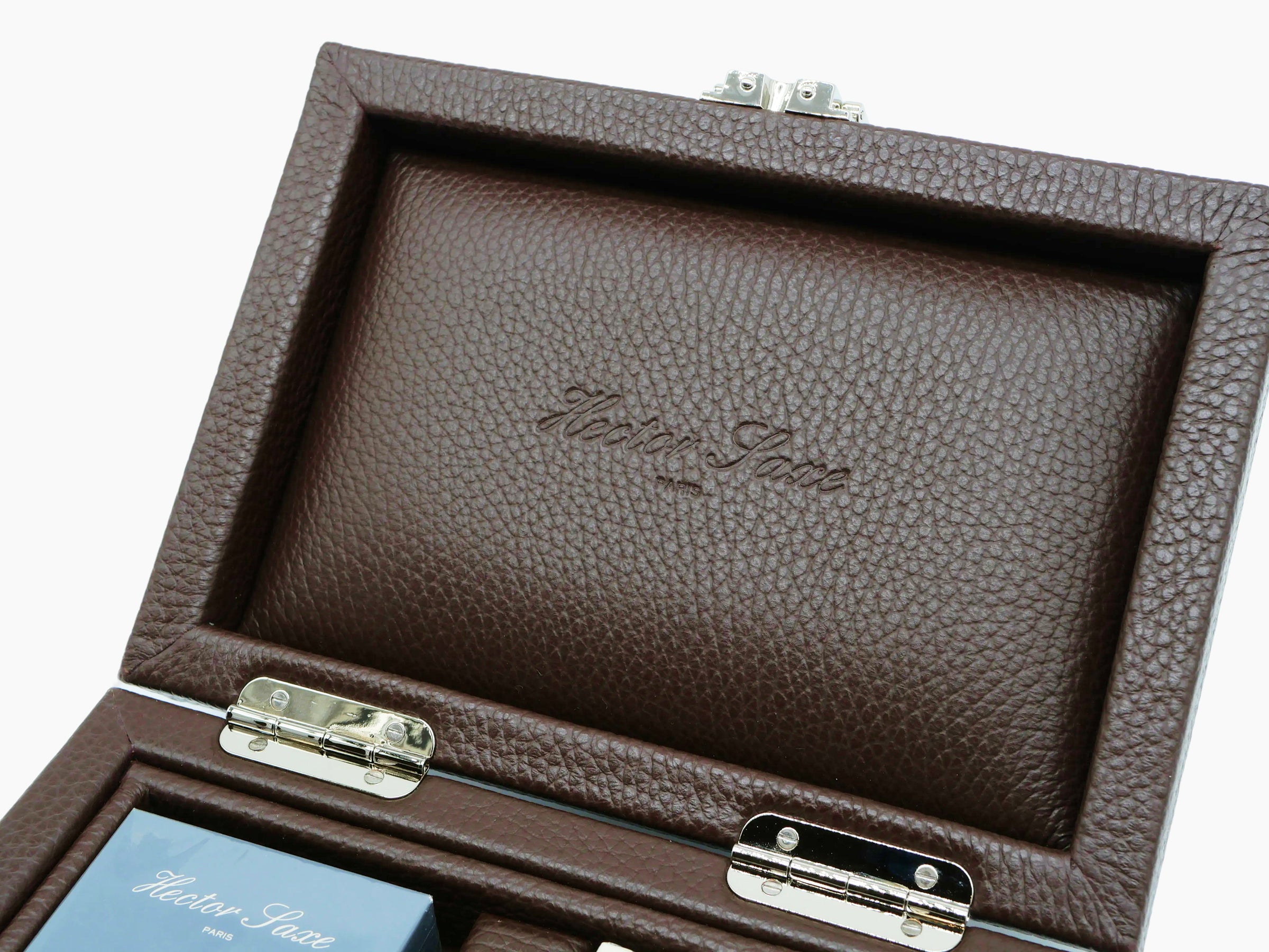 Close-up of the interior lid of the brown buffalo leather box showing embossed script.
