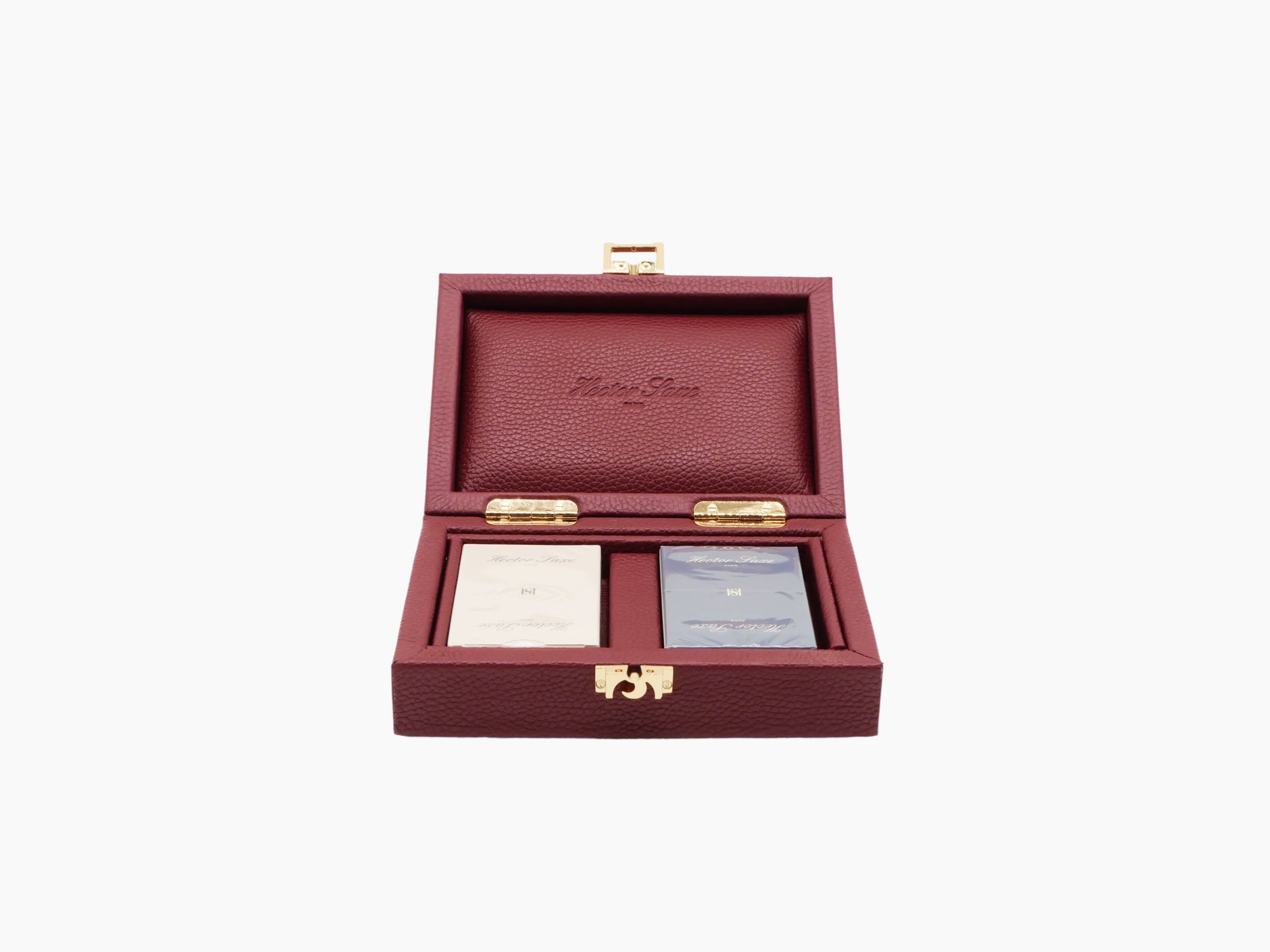 Open burgundy buffalo leather card box with geometric textile lining and two decks inside with gold clasps