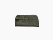 Khaki alligator-embossed glasses case with a strap detail.