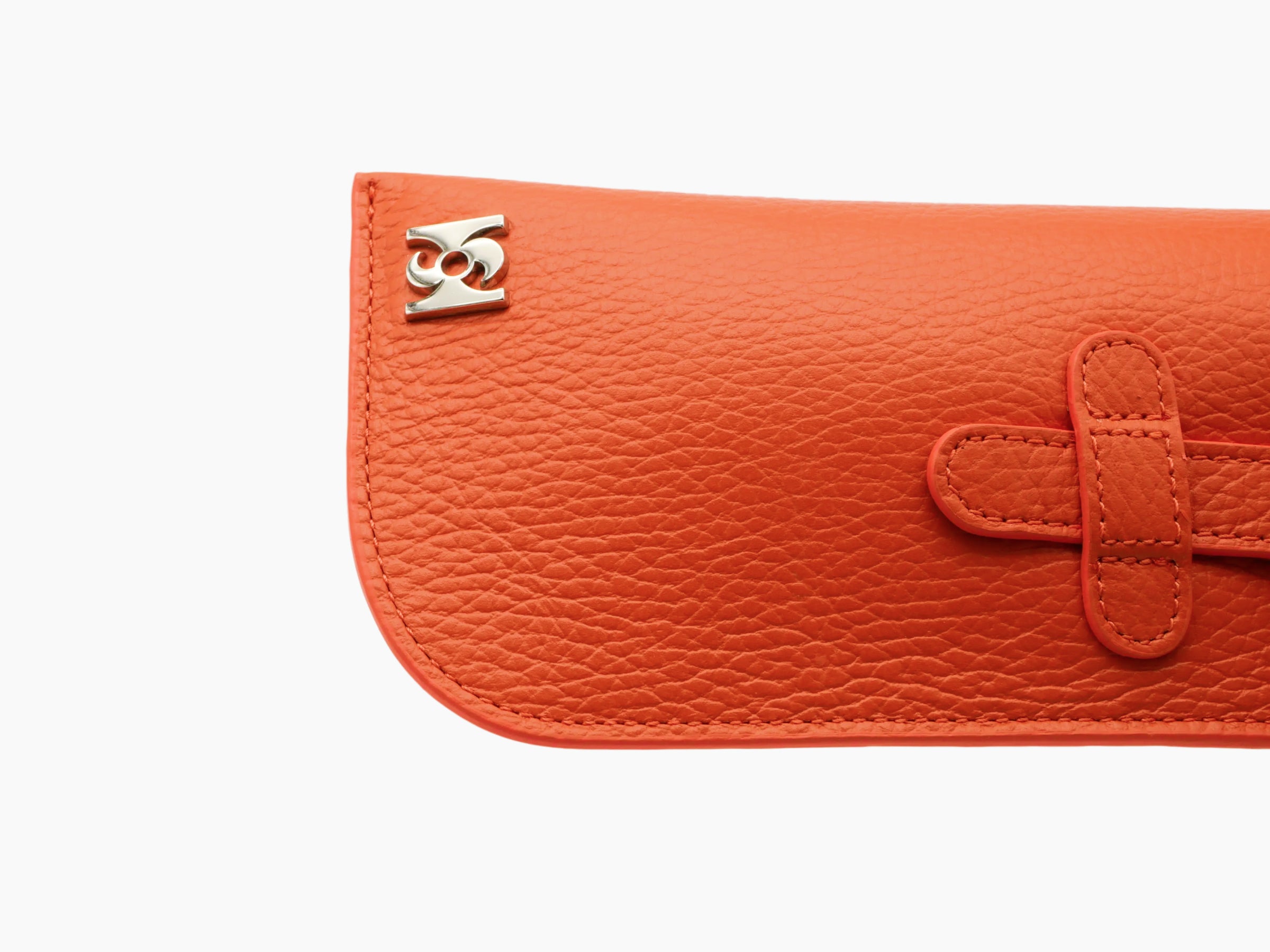Close-up of orange Buffalo leather glasses case showing strap and corner metal logo.