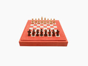 Coral red leather chess box with a built in board visible on top and matching leather exterior