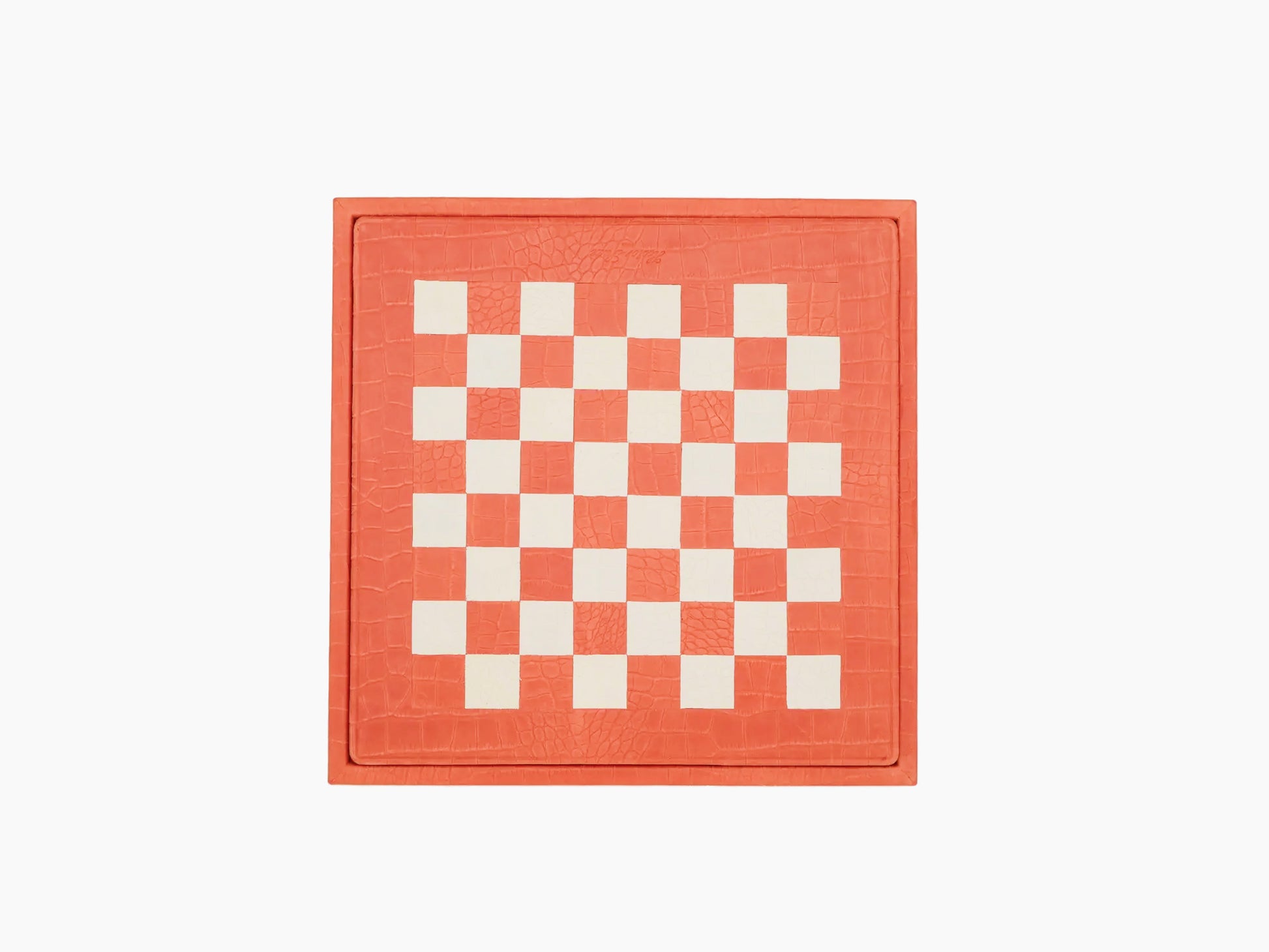 Top view of coral alligator leather chessboard with a white checker pattern and stitched leather border.