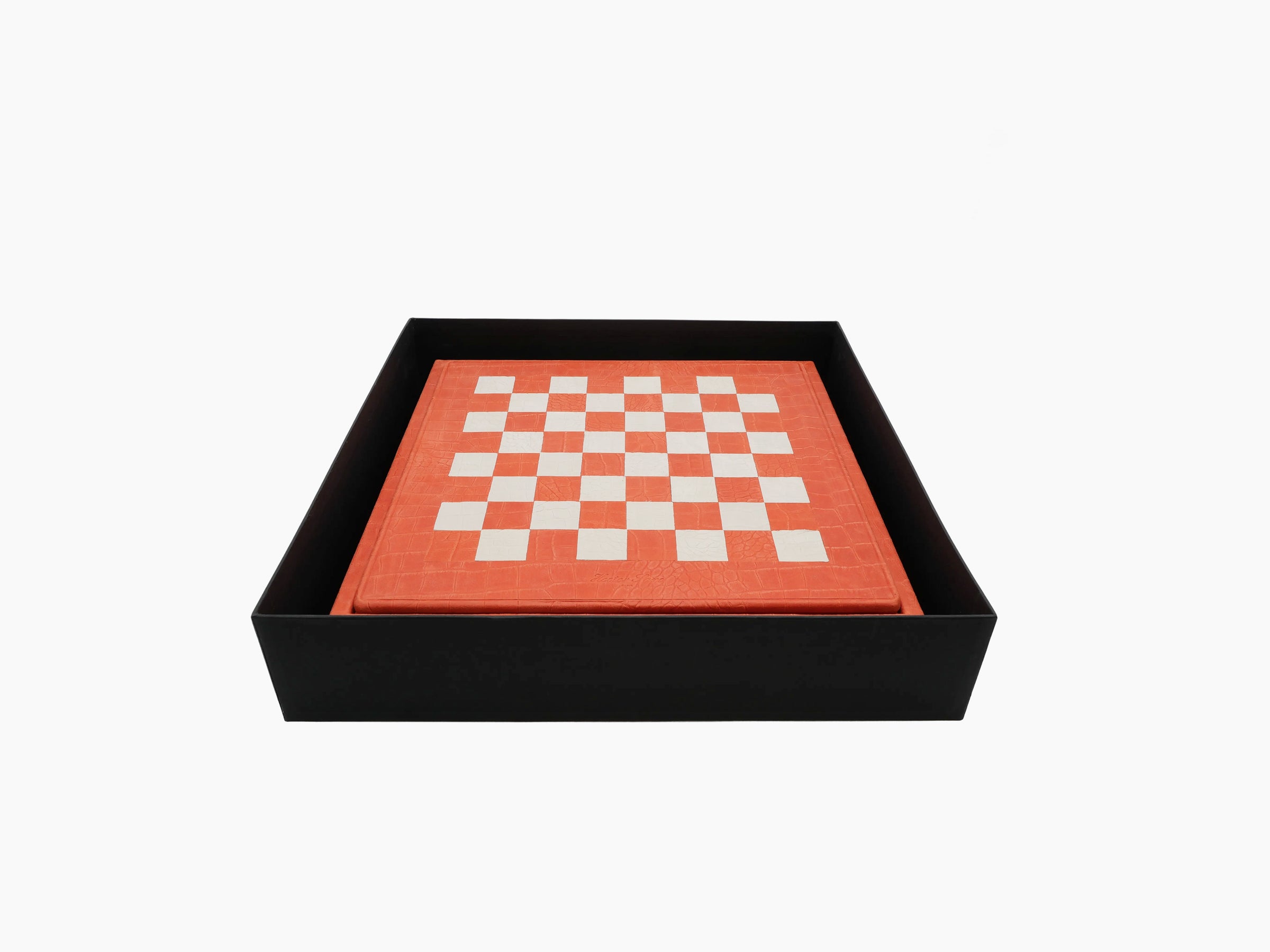 Coral orange chessboard with white squares placed inside a black protective box