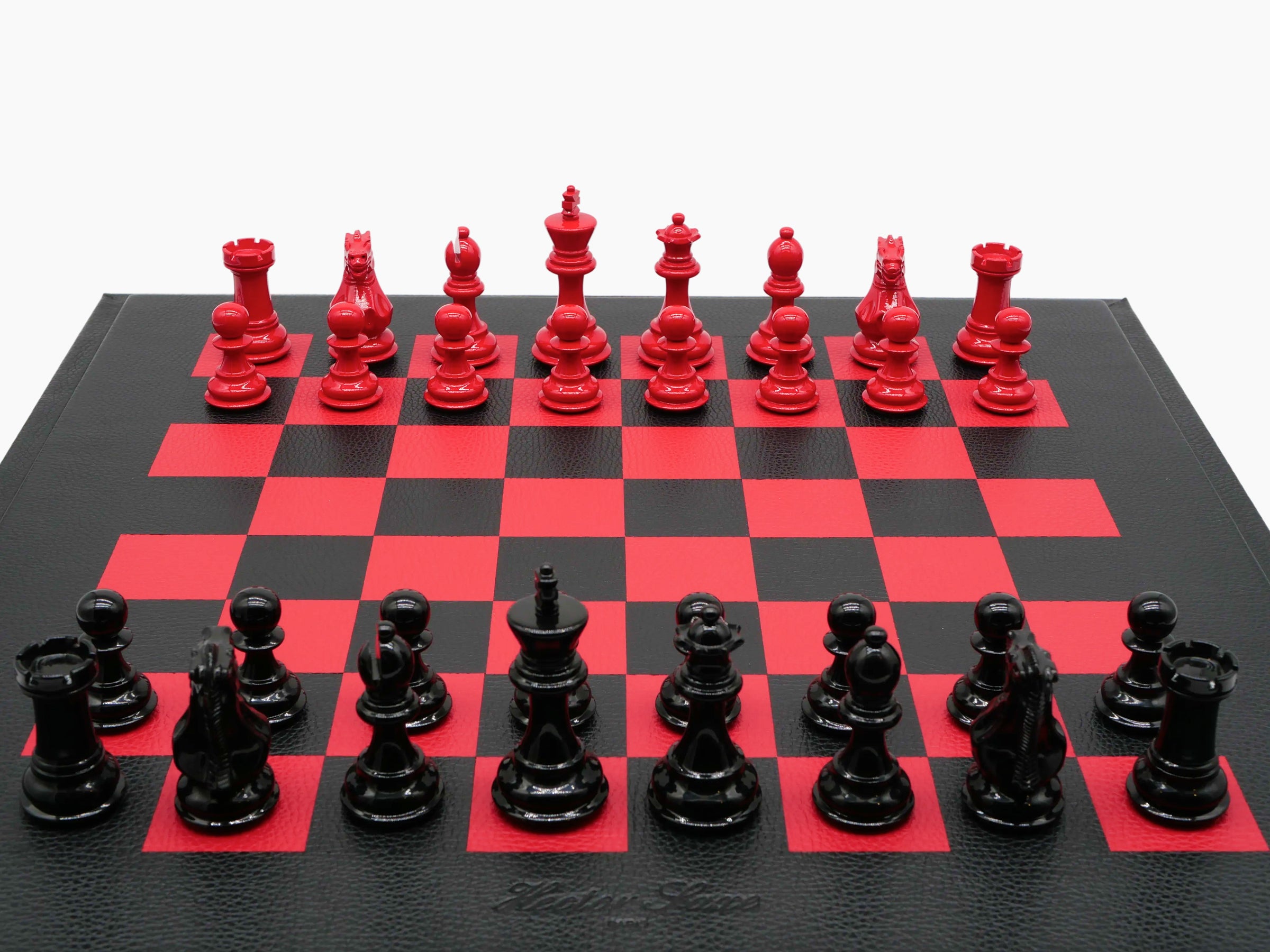 Buffalo Red Black chess set on a textured leather board with red and black pieces in the opening position