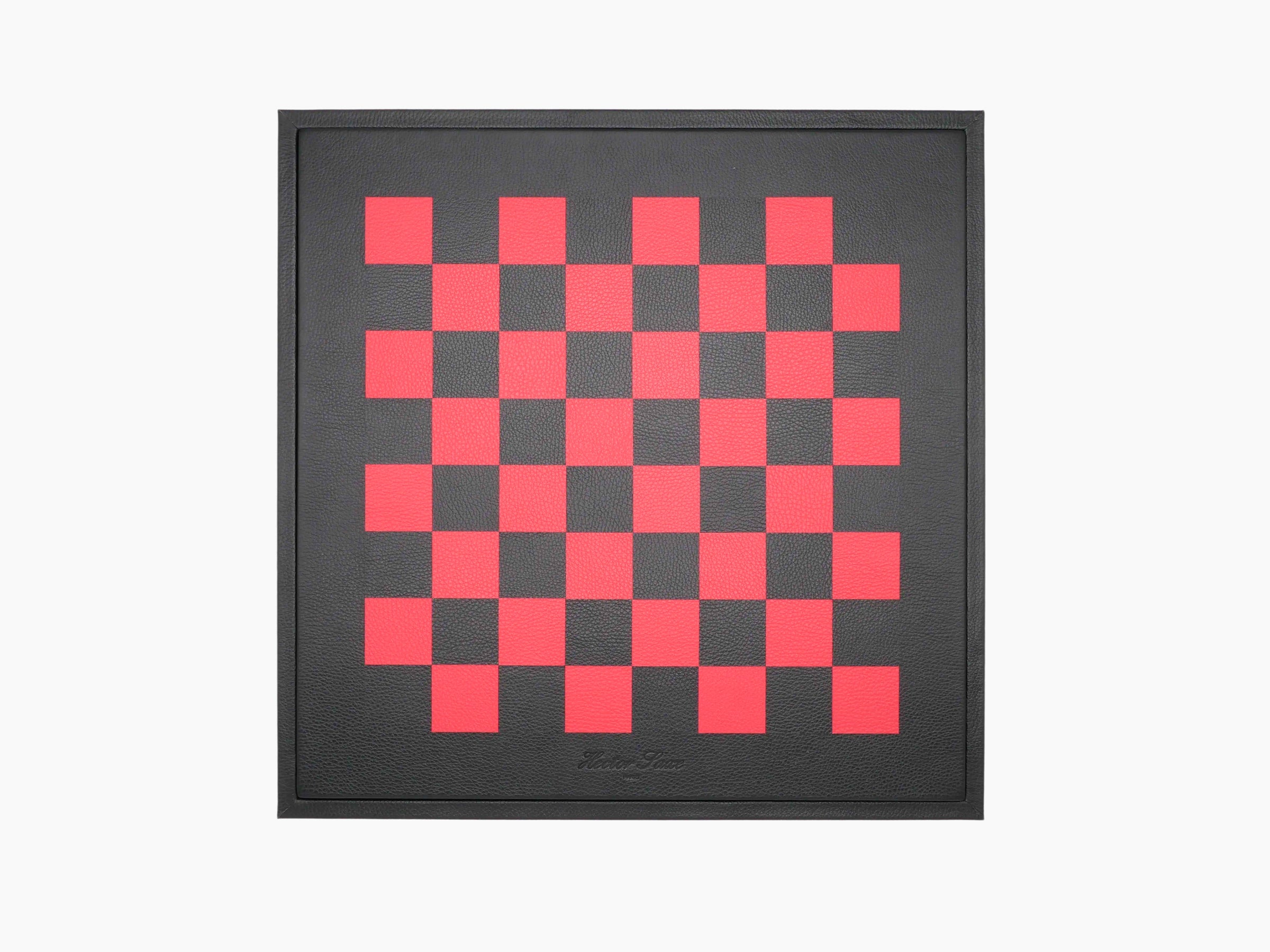 Top view of the leather wrapped chessboard lid showing a red checkered pattern on a dark background