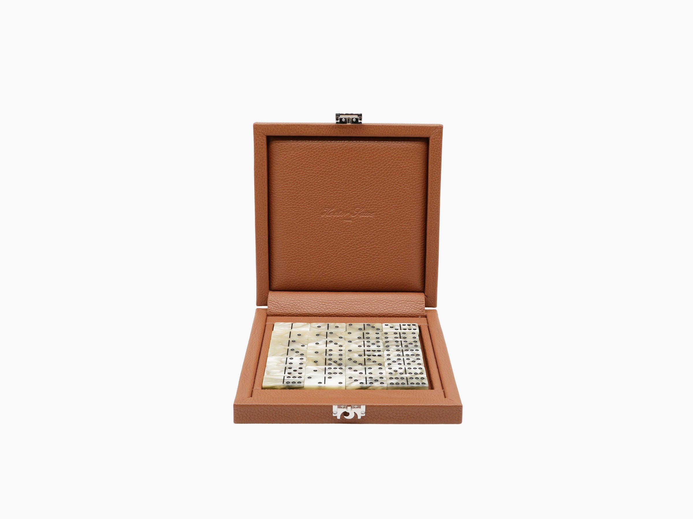 Open brown leather box containing Buffalo Gold domino set with cream two-tone tiles inside