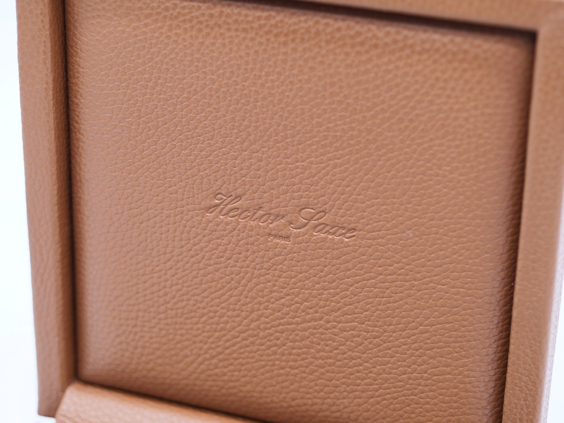 Close up of textured brown leather interior with Hector Lane Paris embossing inside a luxury domino case.