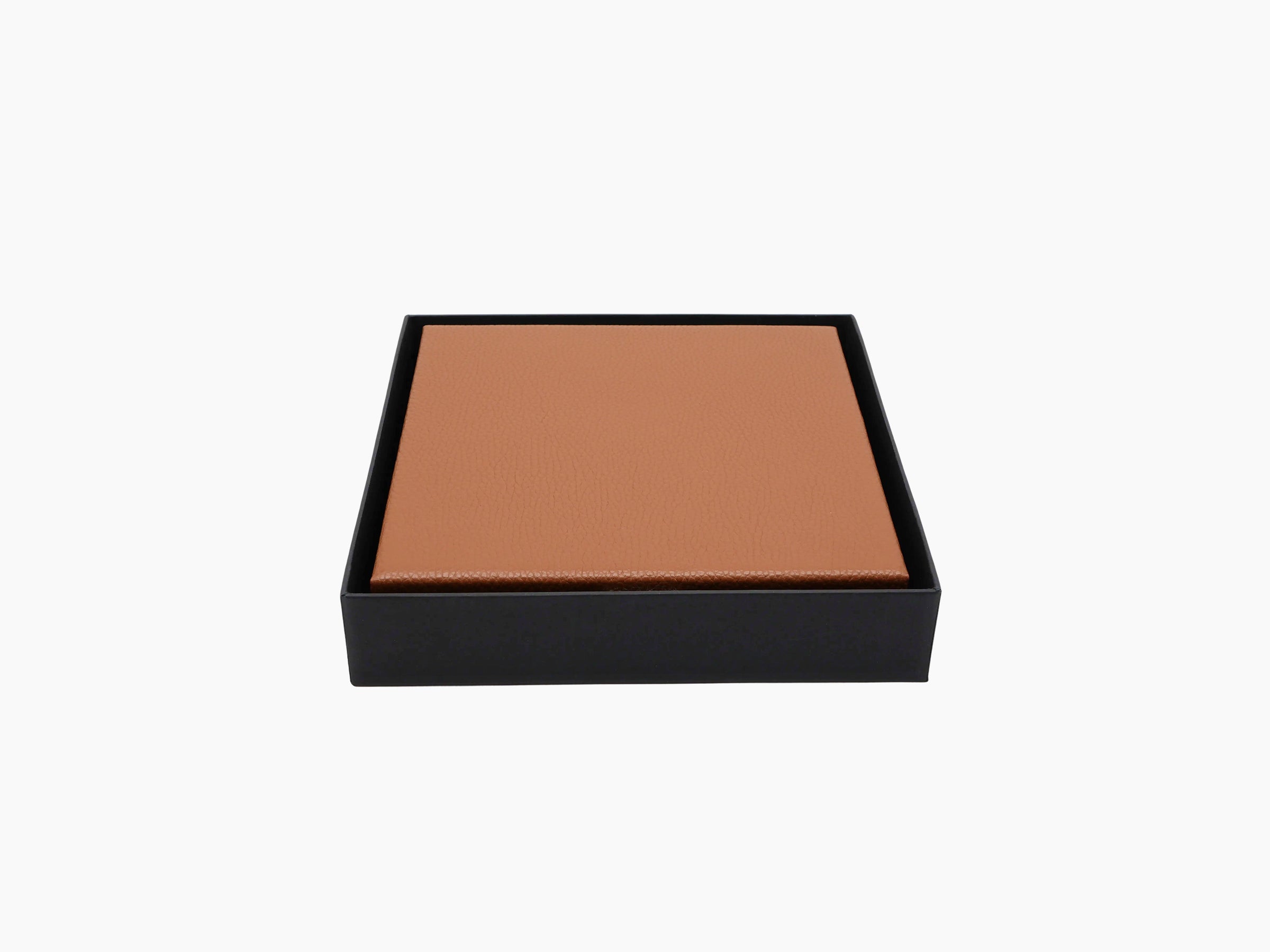 Tan leather wrapped domino case nestled in a black rectangular gift box