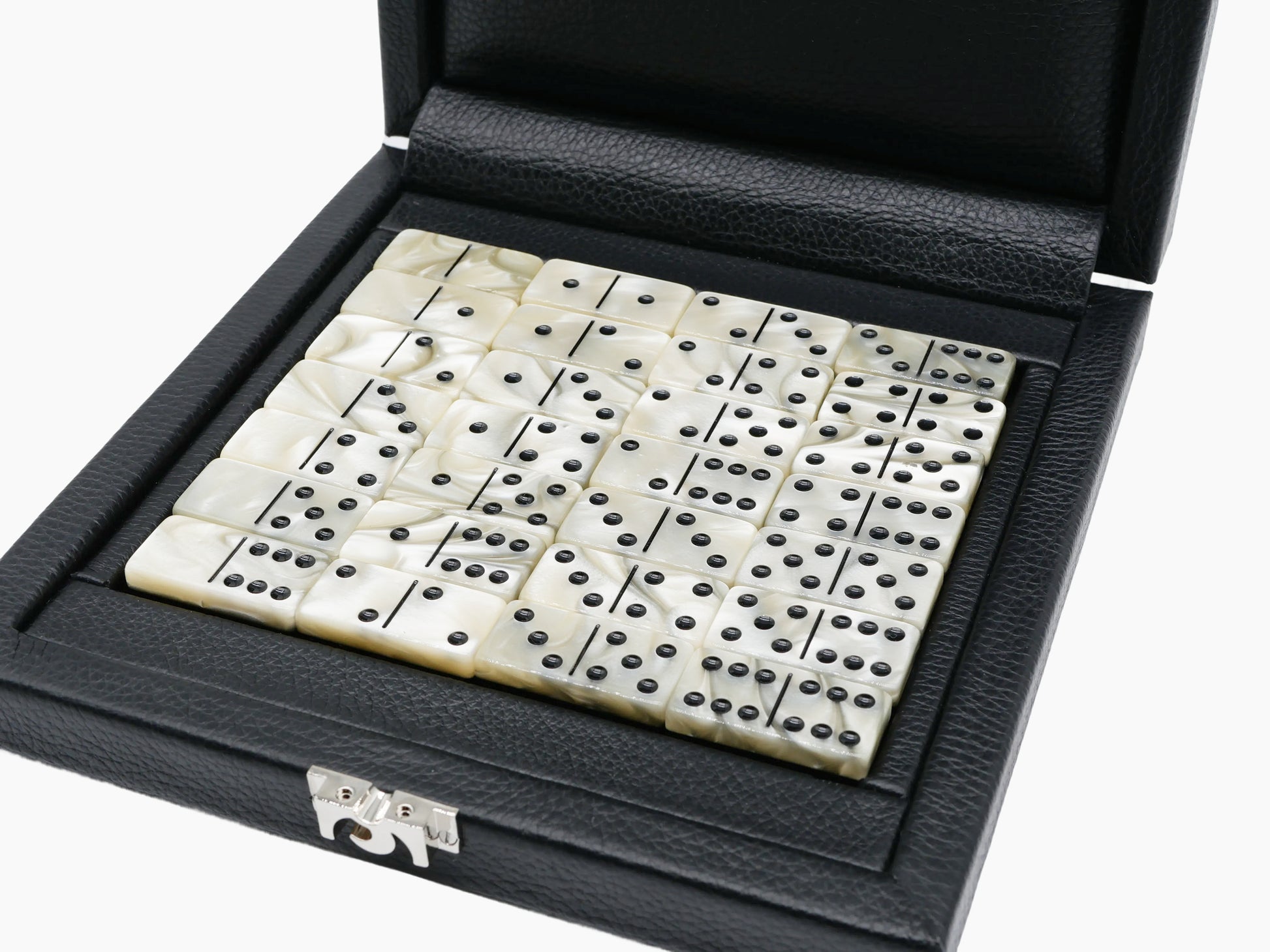 Open black leather domino case filled with ivory two tone domino tiles with black pips