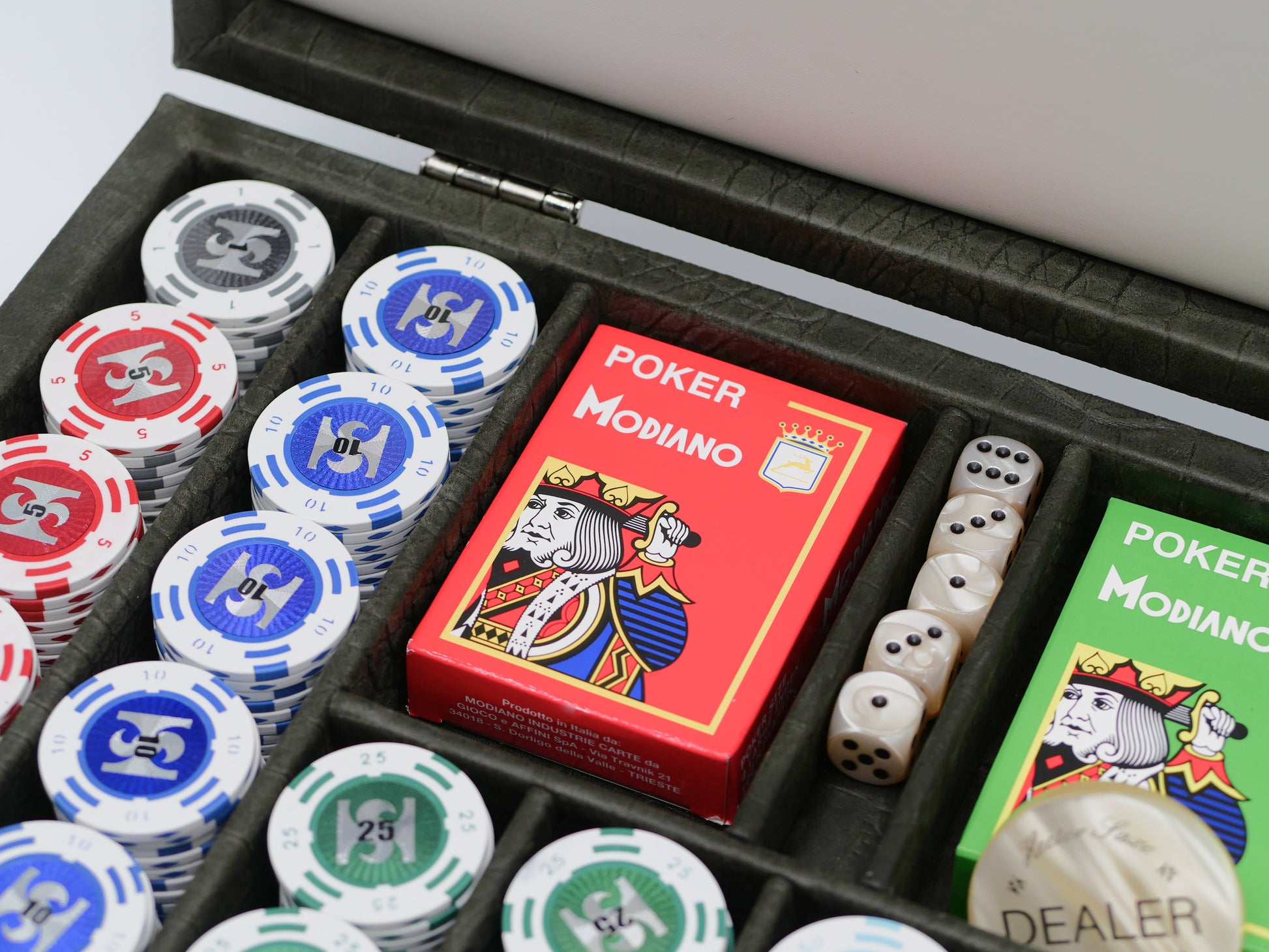 Open poker set with red Modiano deck box, green Modiano box, white dice in a tray, and protective case interior