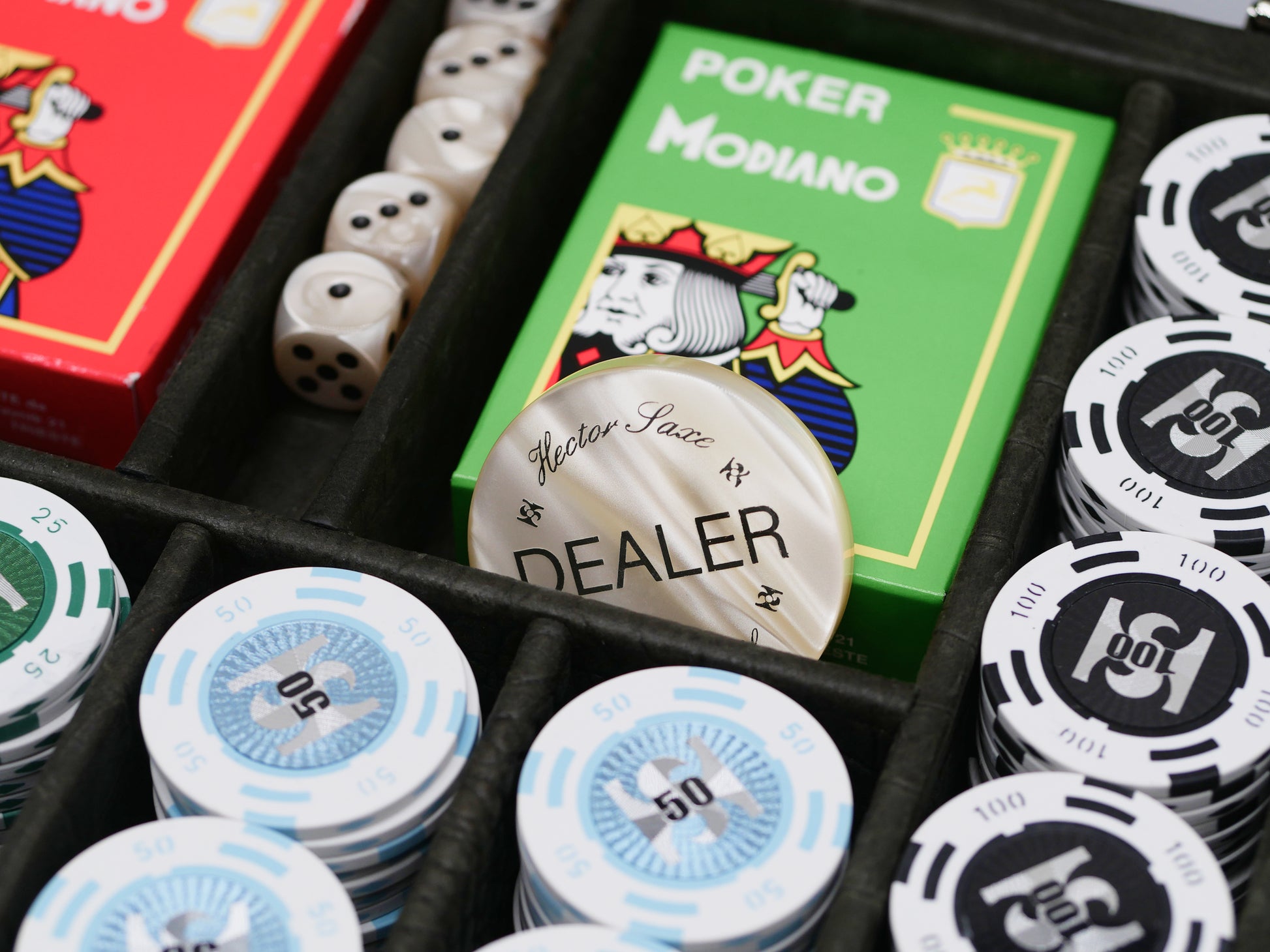 Luxurious alligator-embossed poker set in a black case with green red Modiano decks and stacked chips with a dealer button
