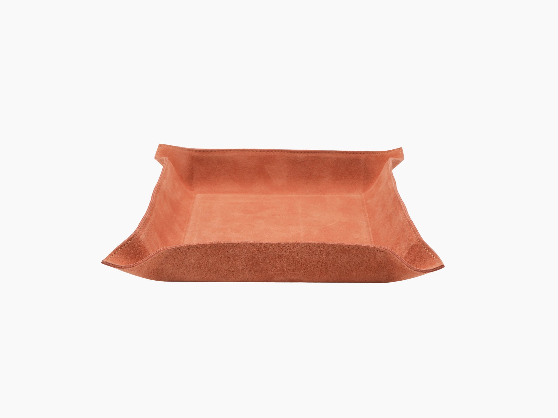 Top-down view of square orange leather valet tray showing interior and rounded corners