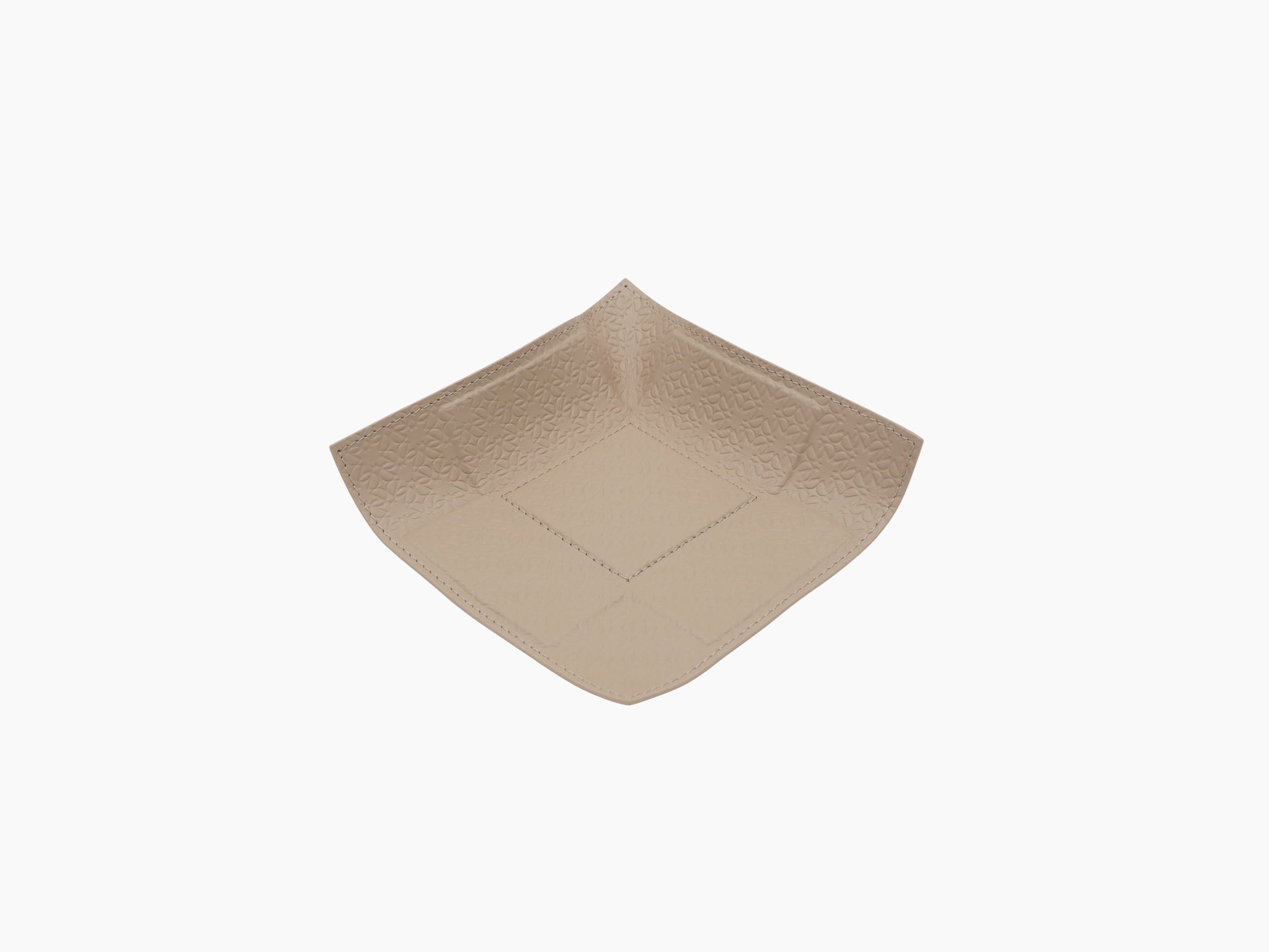 Light tan leather valet tray with Elie Saab monogram embossing and curved rounded corners.