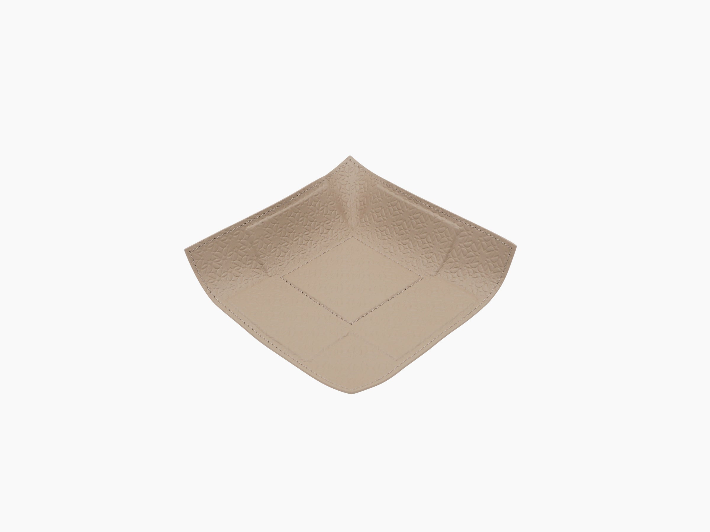 Light tan leather valet tray with Elie Saab monogram embossing and curved rounded corners.