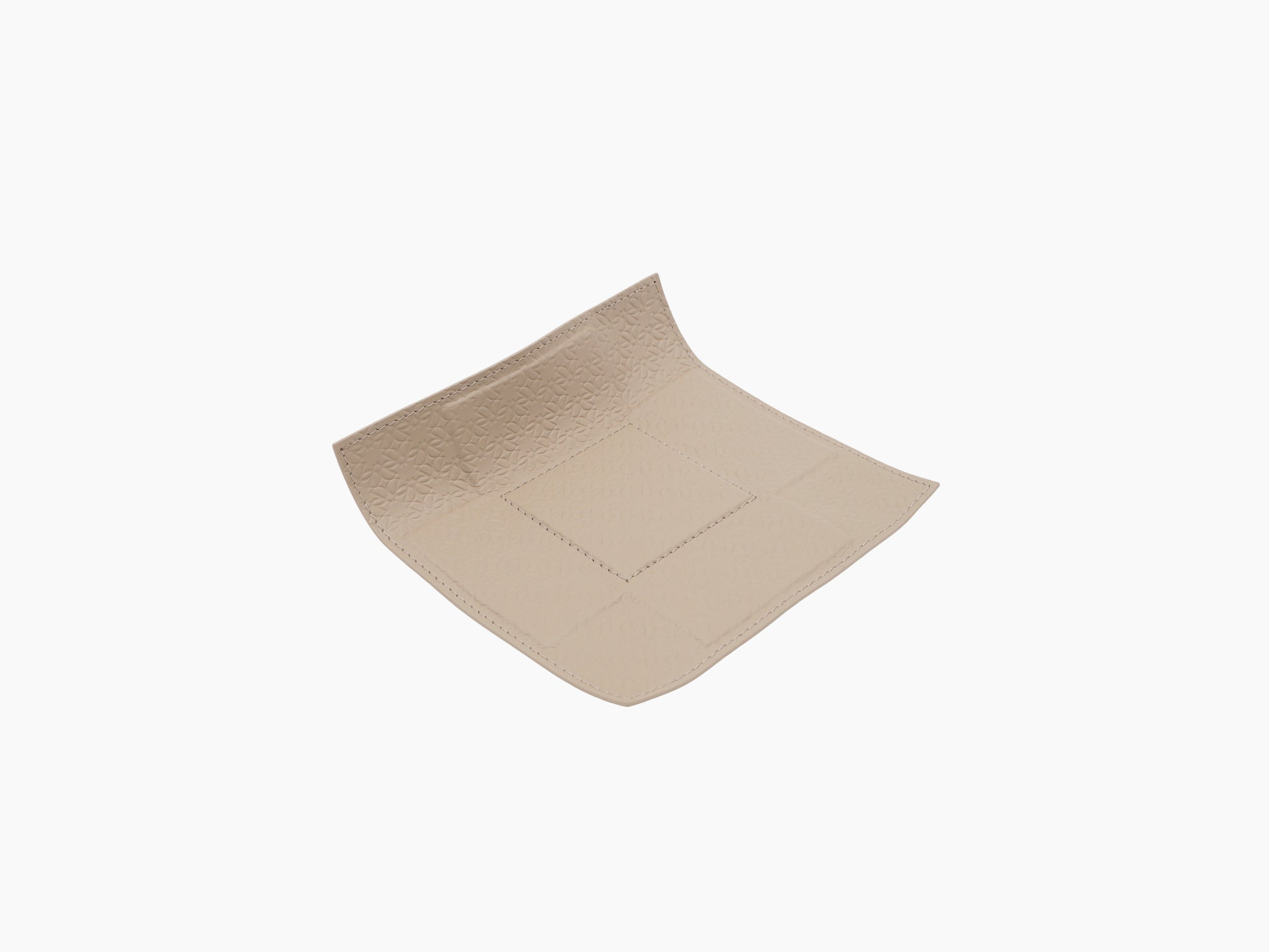Beige leather valet tray with curved corners and a central stitched square inset