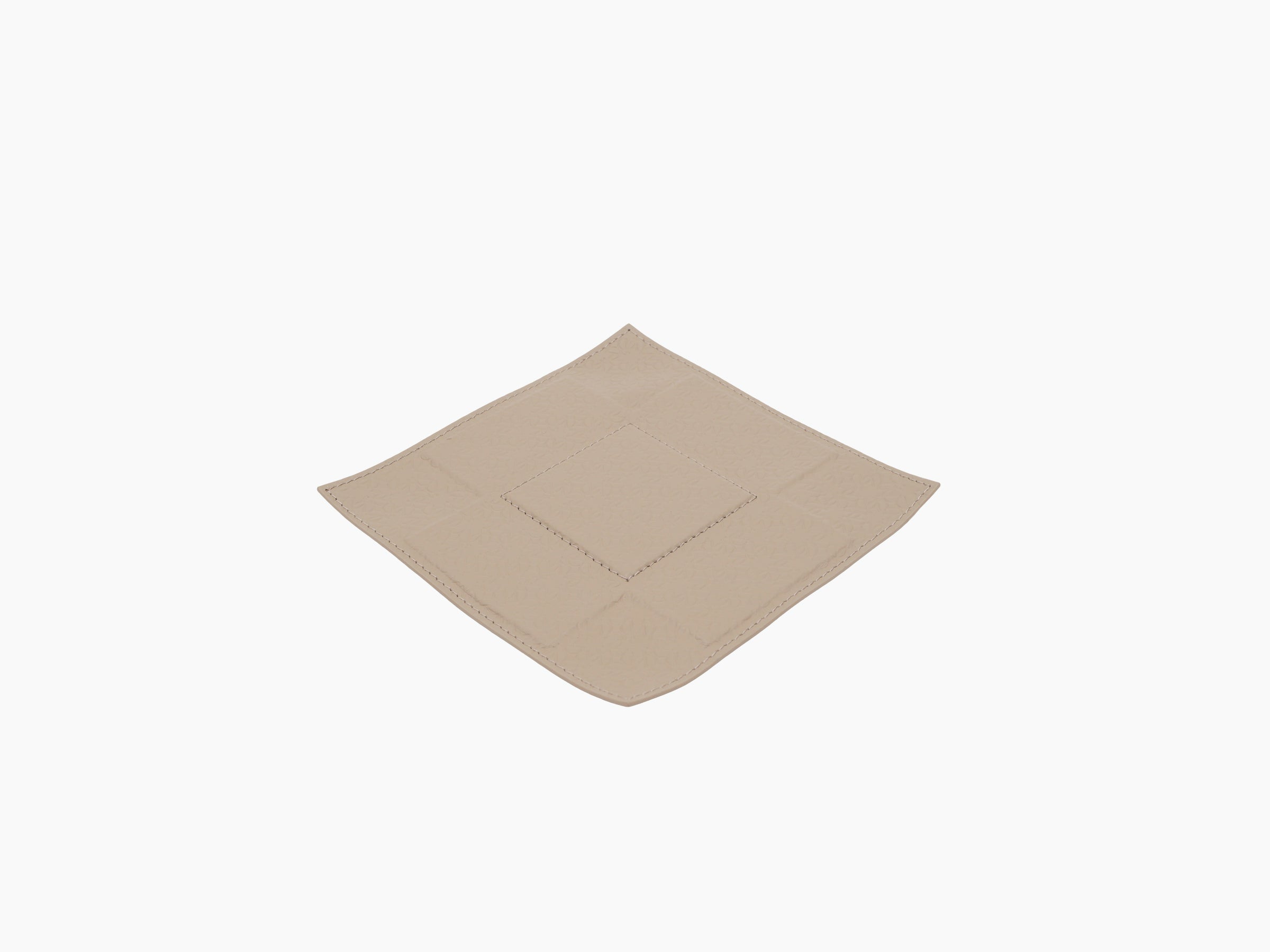 Beige leather valet tray with embossed monogram texture and visible stitching along the edges