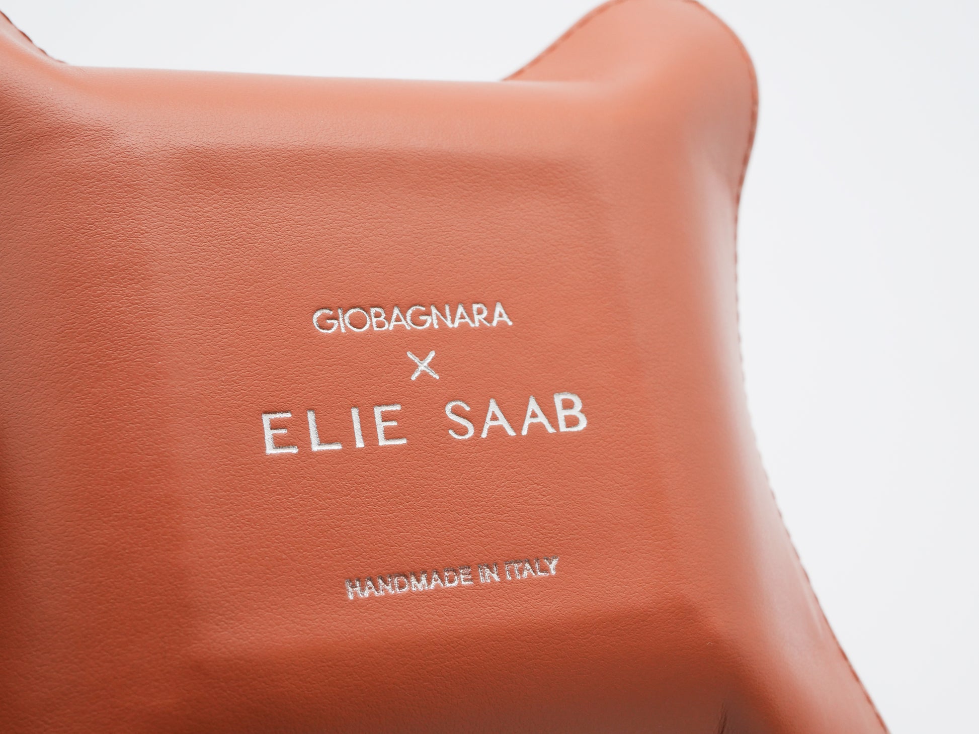 Tan leather square valet tray with Giobagnara X Elie Saab logo in white