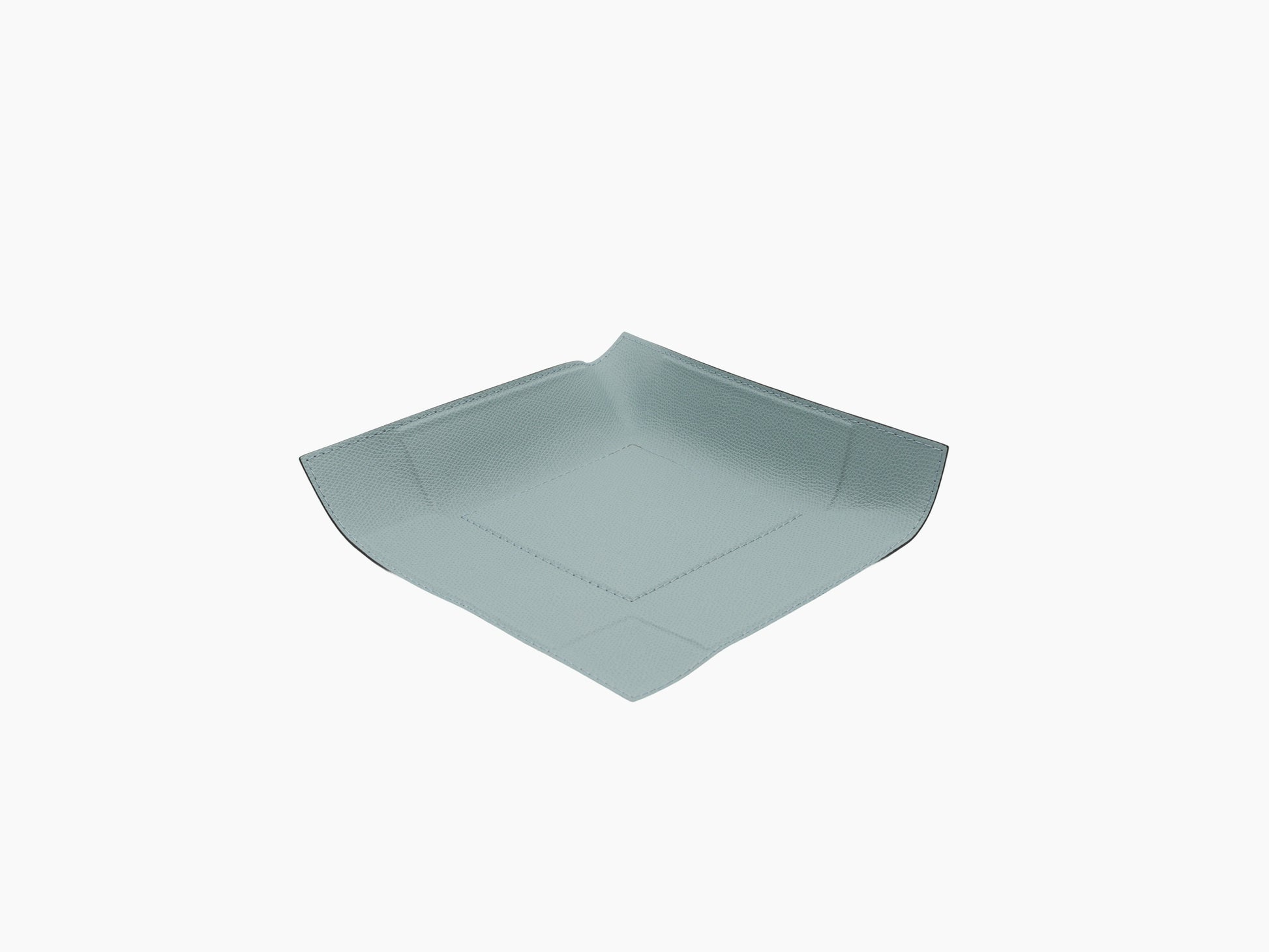 Angled view of light blue leather wrapped square valet tray with curved sides