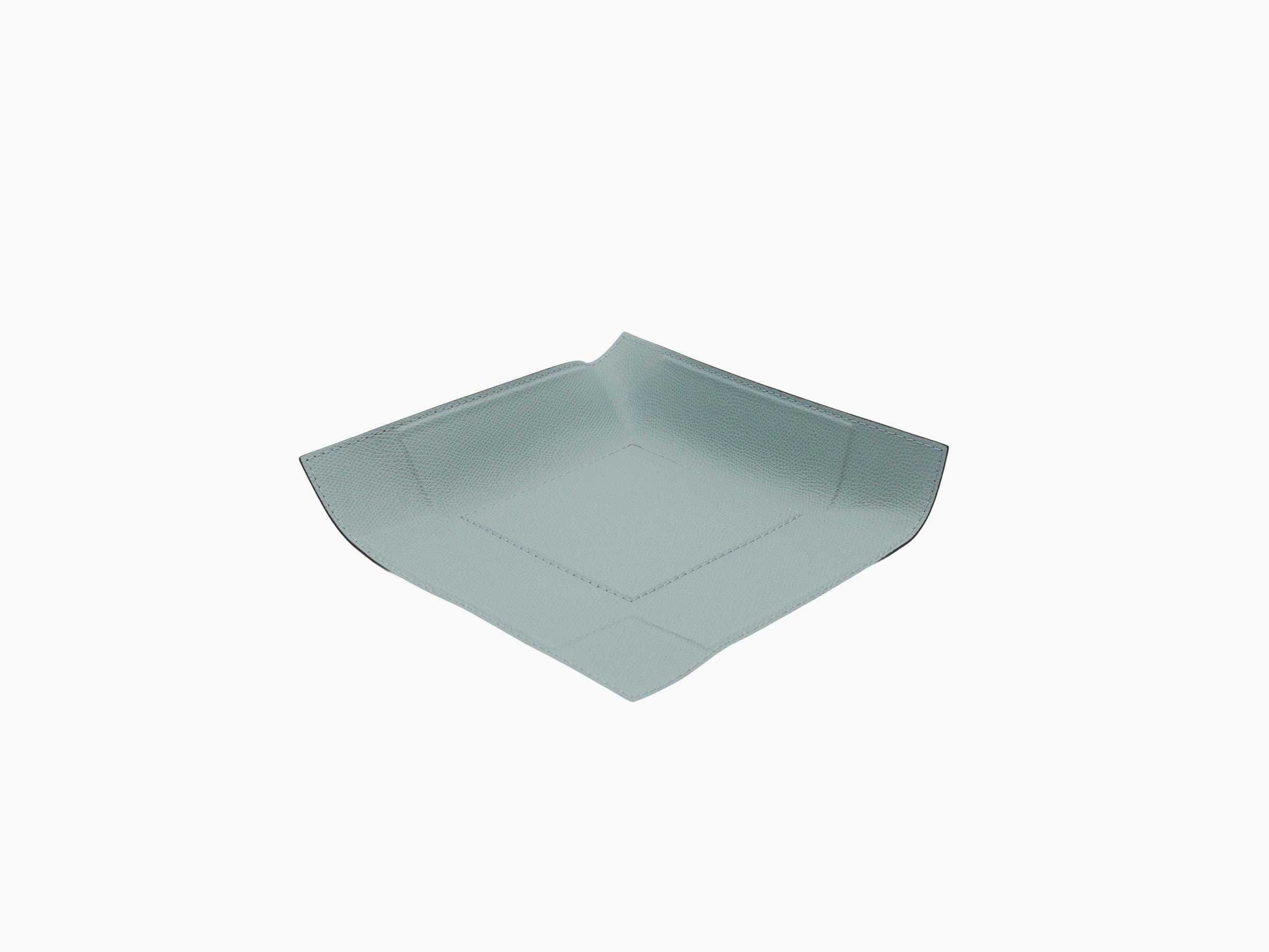 Angled view of light blue leather wrapped square valet tray with curved sides