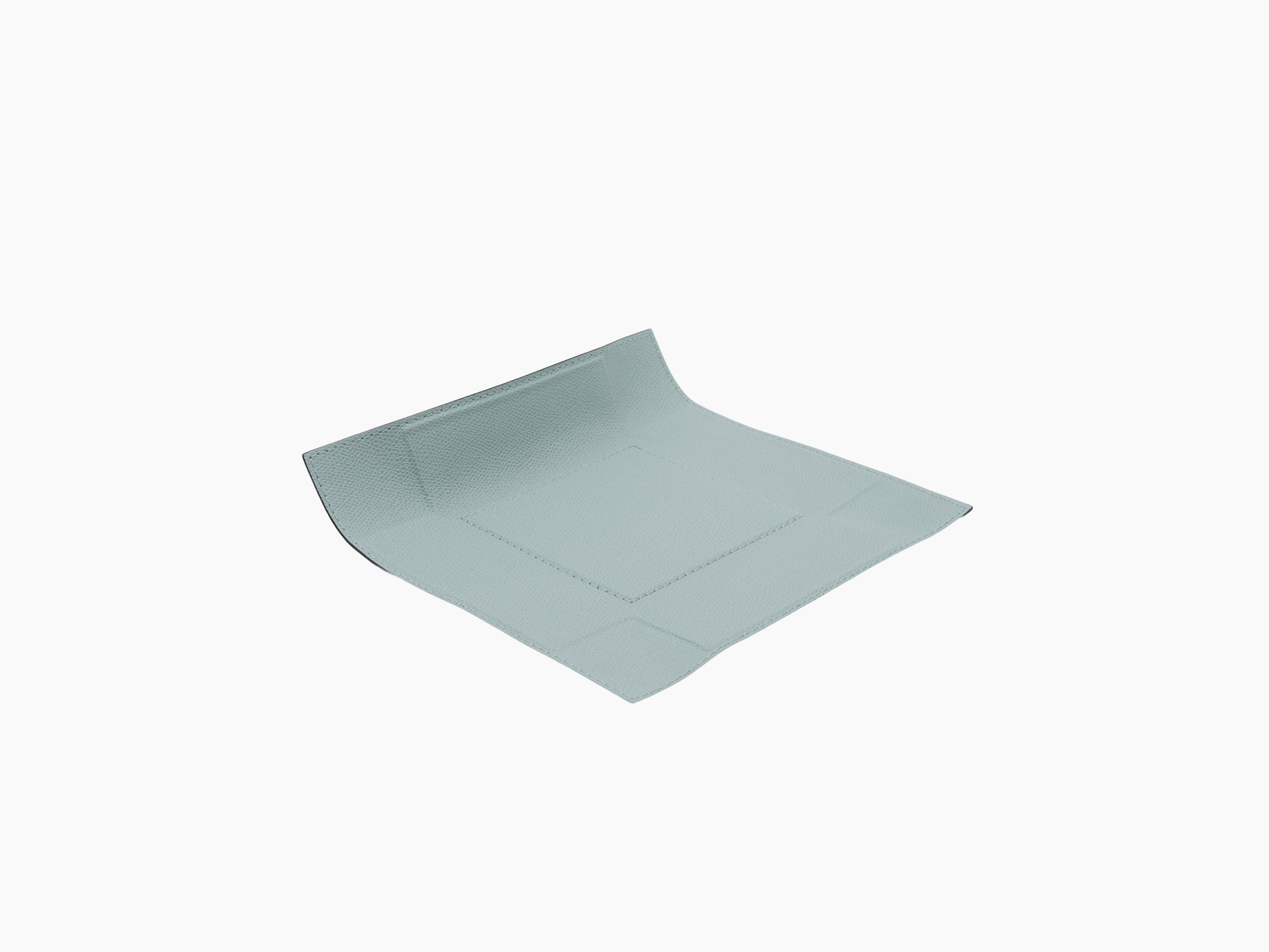 Angle view of light blue leather valet tray with curved edge and stitched border