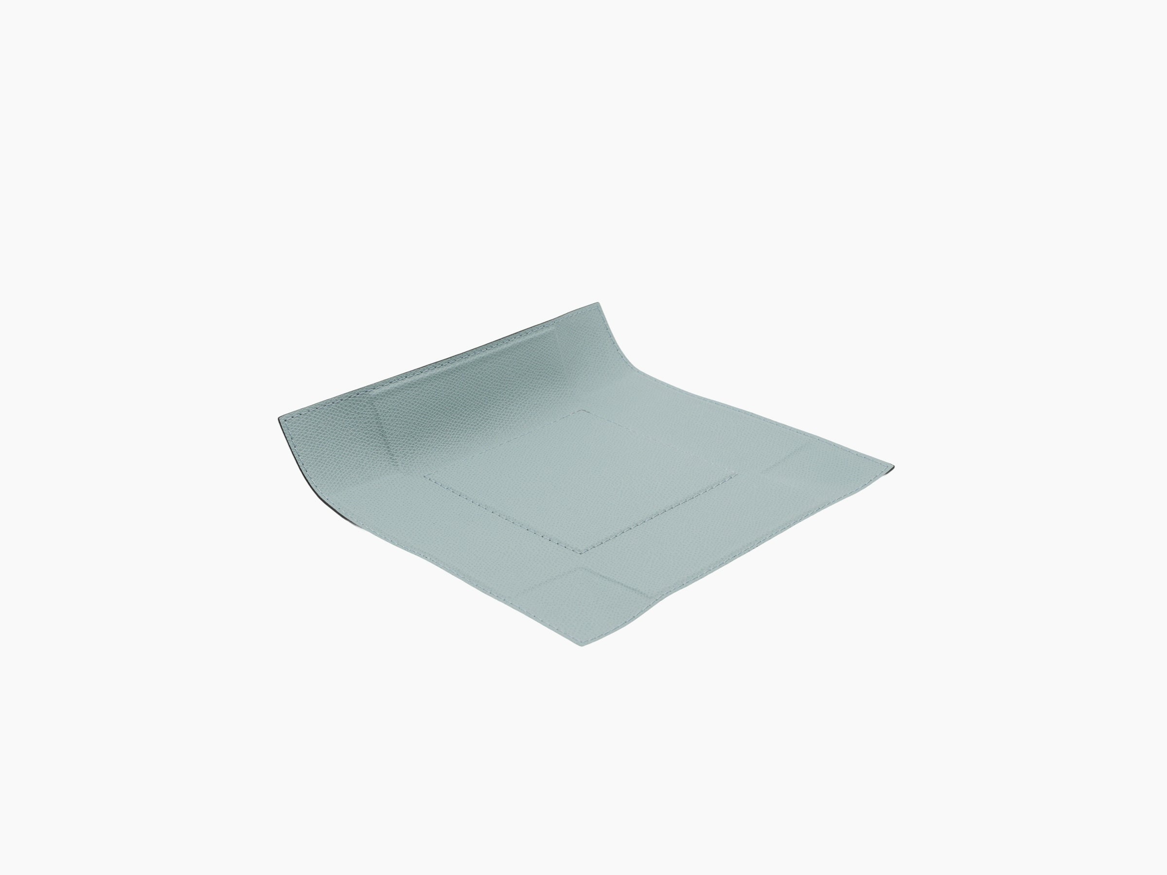 Angle view of light blue leather valet tray with curved edge and stitched border