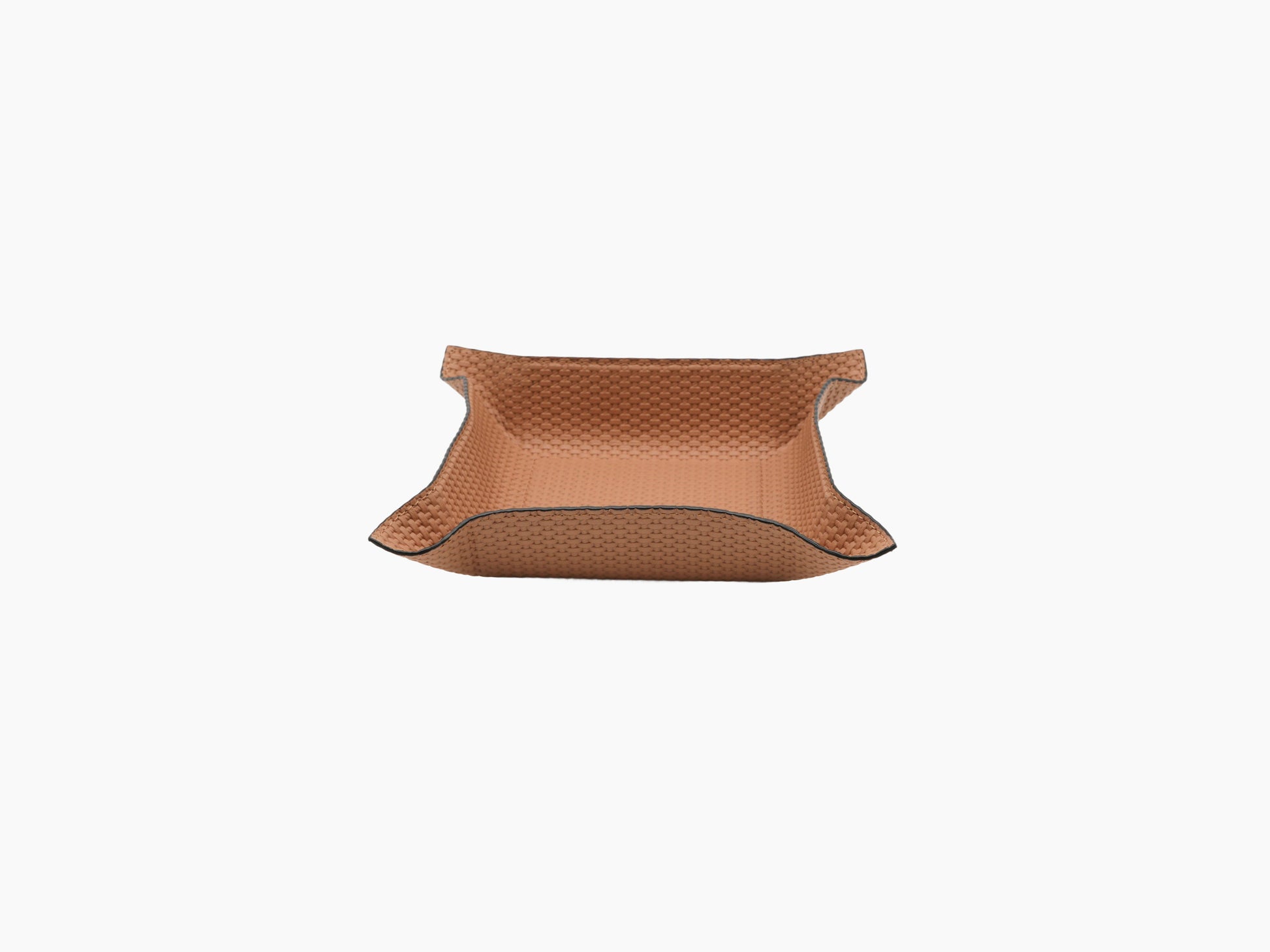 Open tan woven leather valet tray with curved sides and dark edge piping, angled view.