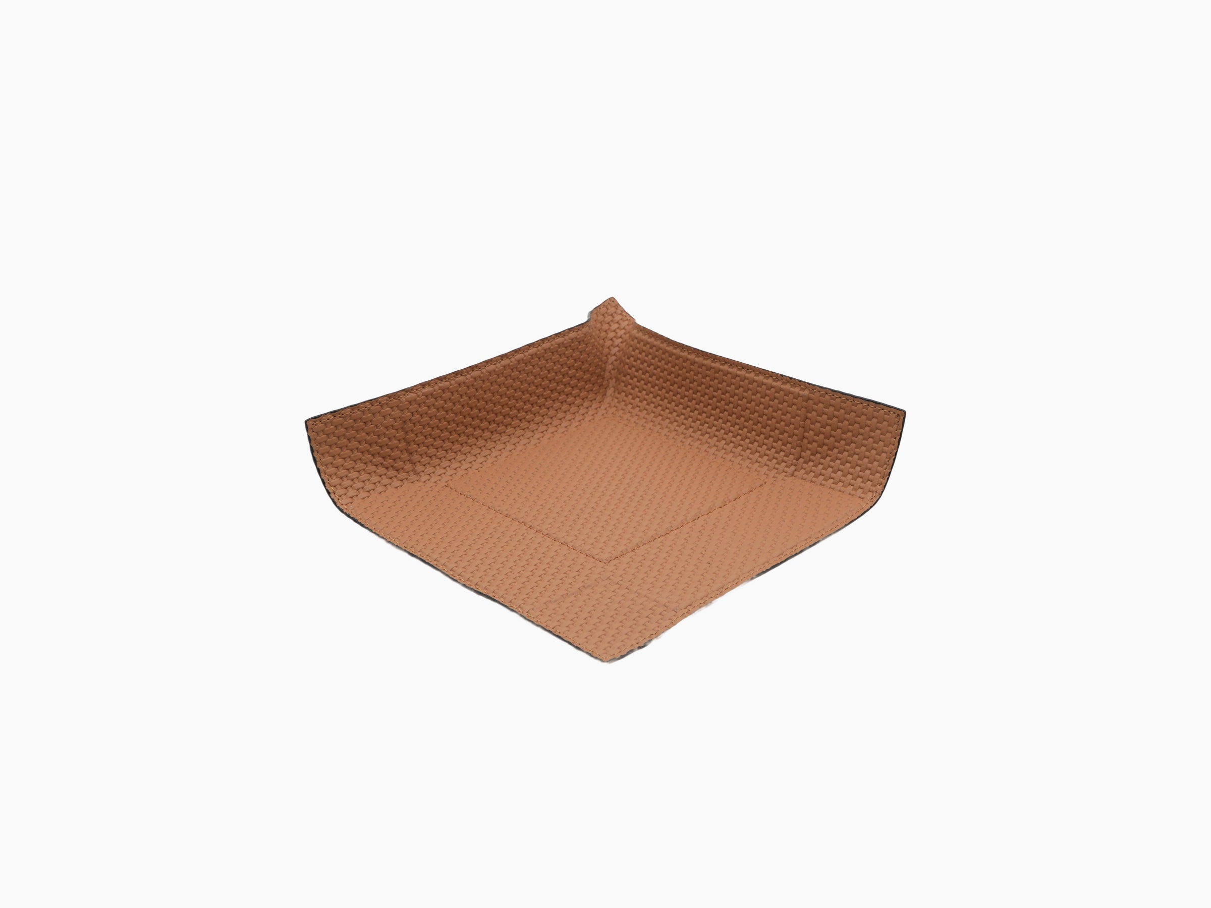 Tan leather wrapped valet tray with square form and textured surface, photographed from an angled perspective.