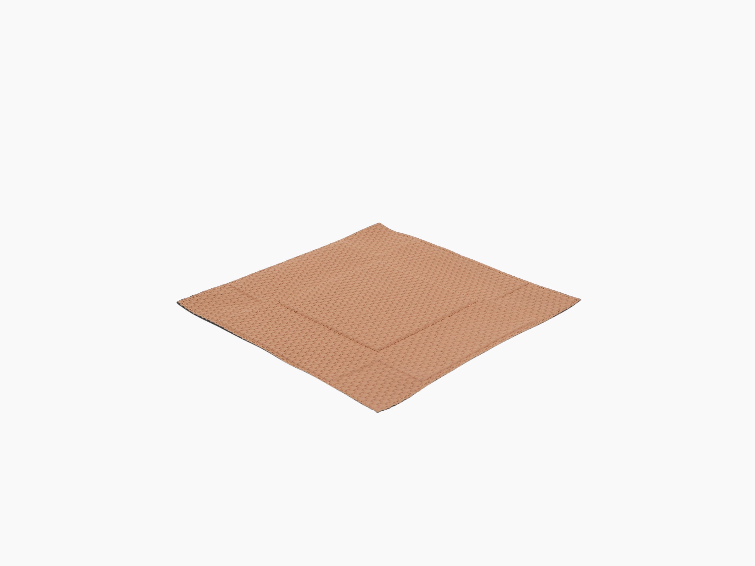 Tan woven leather valet tray square in medium size laid flat with stitched edges.