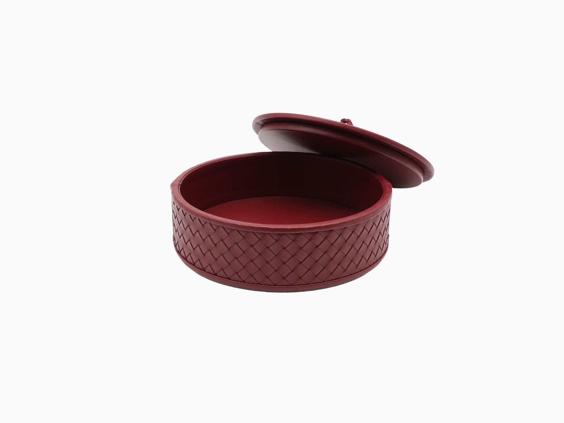 Open Jana round leather box in burgundy with quilted diamond exterior and lid resting nearby