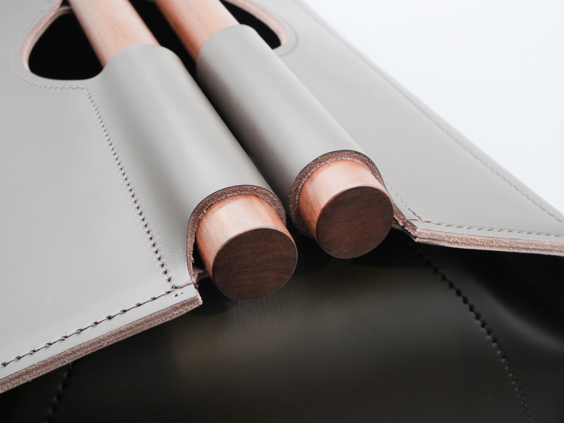 Close-up of Jota rectangular storage basket showing rosewood handles and stitched edges.