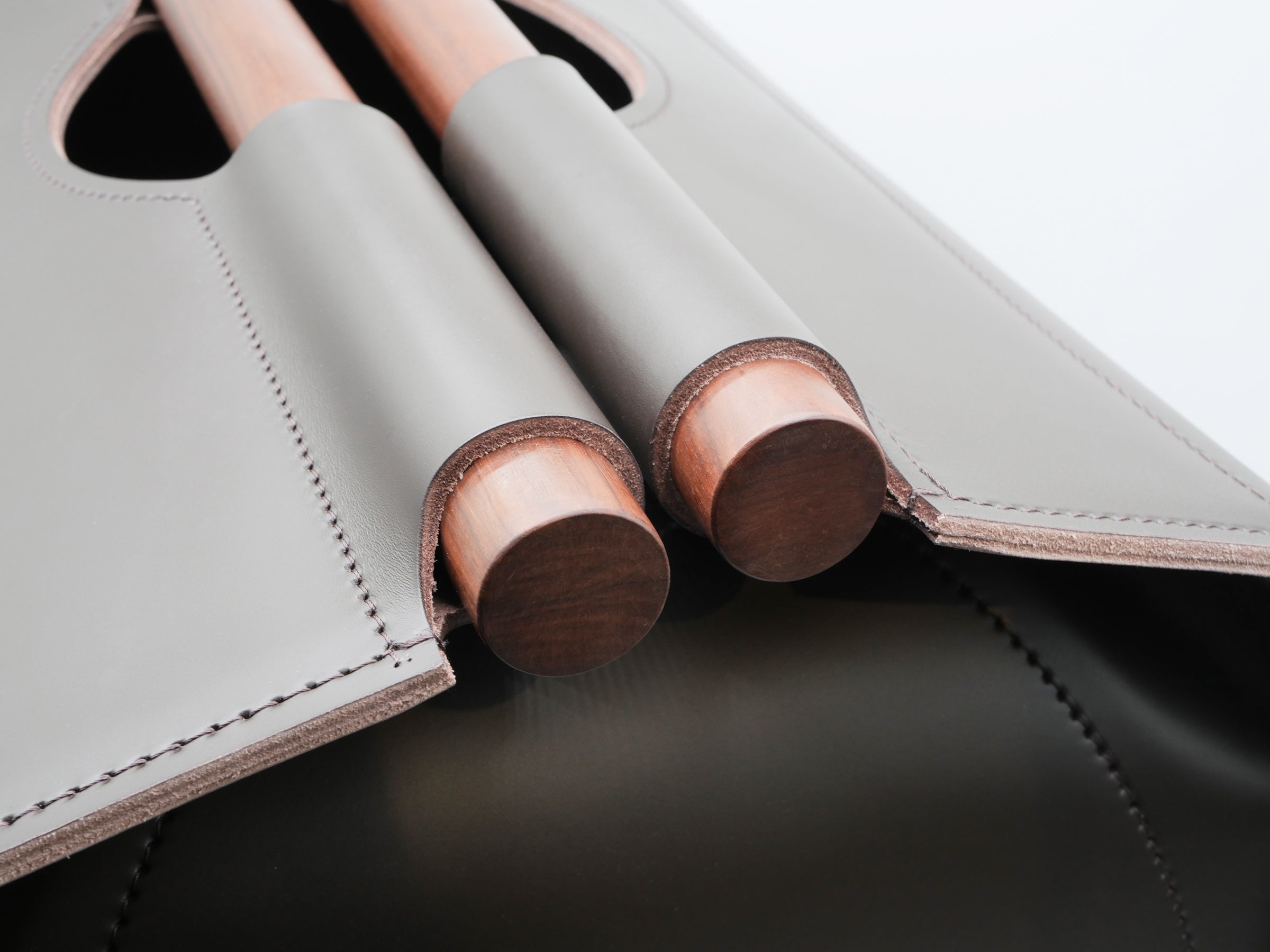 Close-up of Jota rectangular storage basket showing rosewood handles and stitched edges.