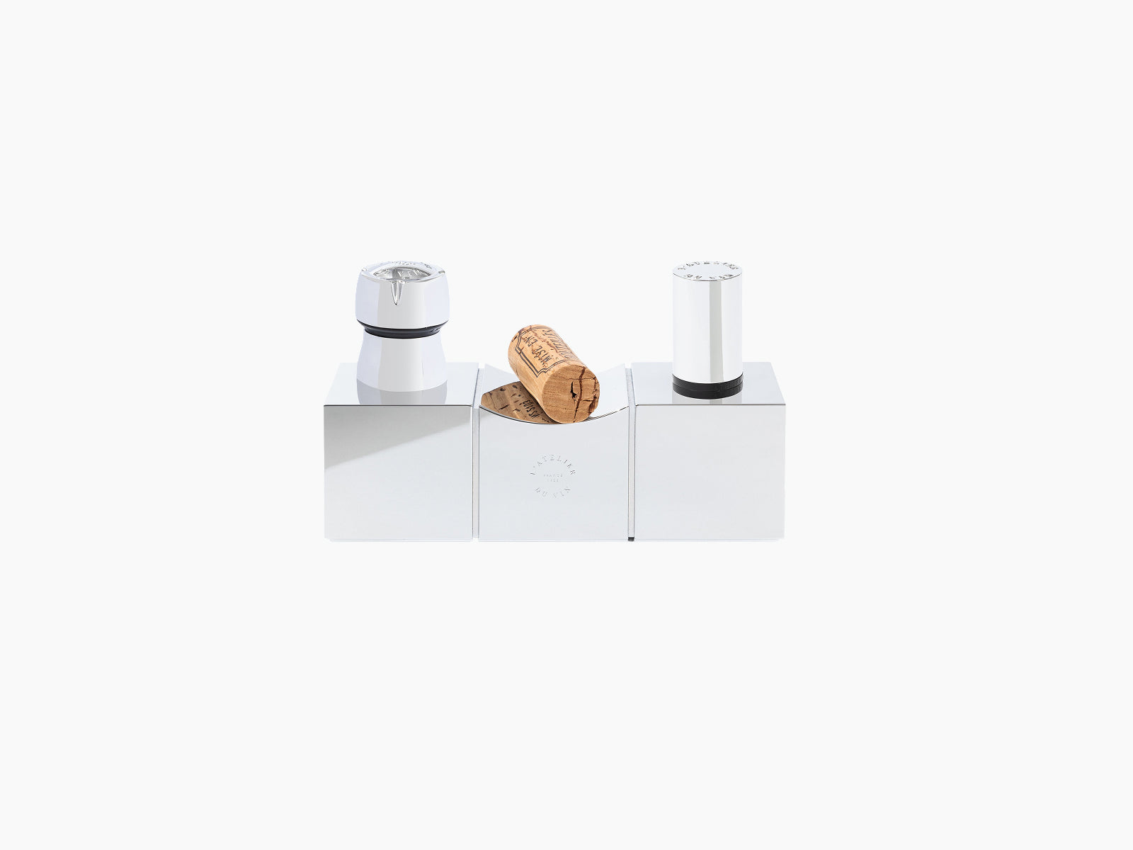 Sculptural cork display centerpiece in polished silver aluminum with a cork resting on the middle block and chrome caps on the sides