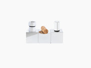 Sculptural cork display centerpiece in polished silver aluminum with a cork resting on the middle block and chrome caps on the sides