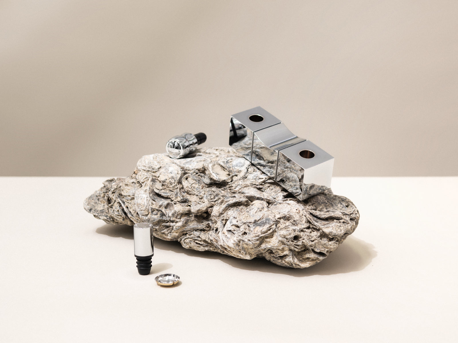 Shiny aluminum bouchons components arranged on a rough rock with cork and metal accessories