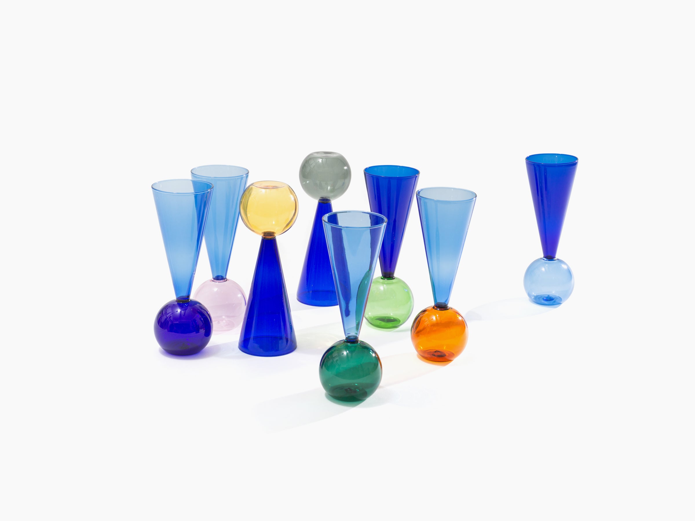 Assorted Bubbles Celebration glass flutes with multicolored spherical bases arranged on a white background