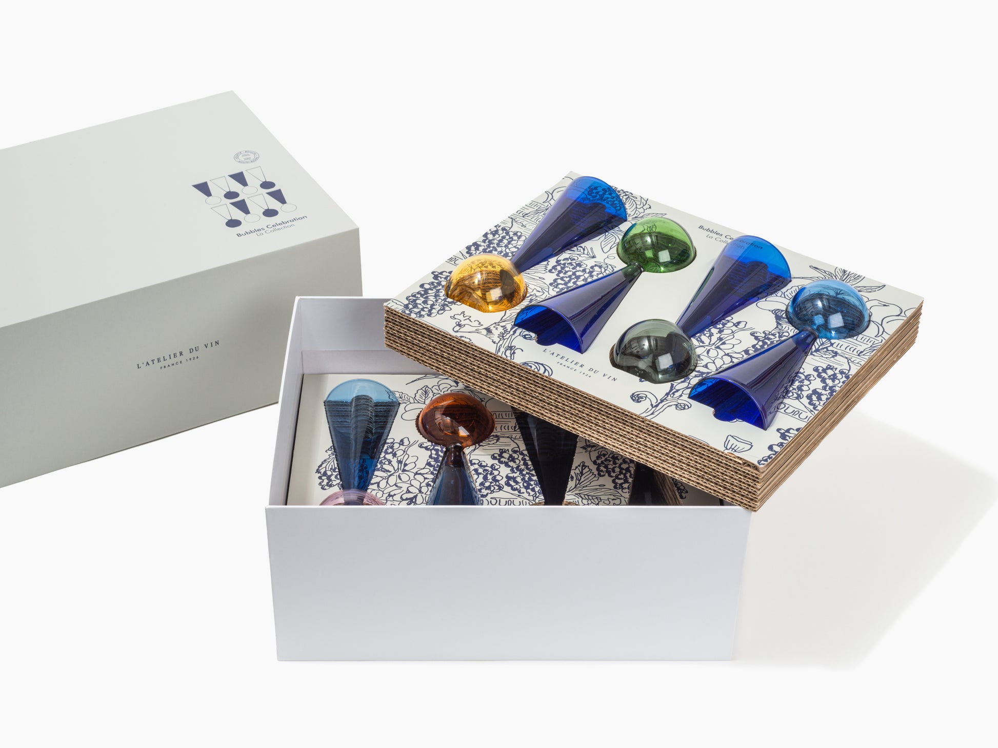 Open white box with a patterned lid displaying colorful Bubbles Celebration glass flutes