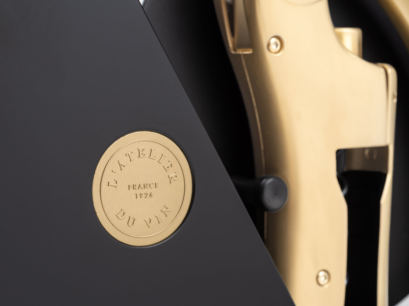 Close up of Geometry black box with a gold emblem and the gold Oeno Motion corkscrew visible