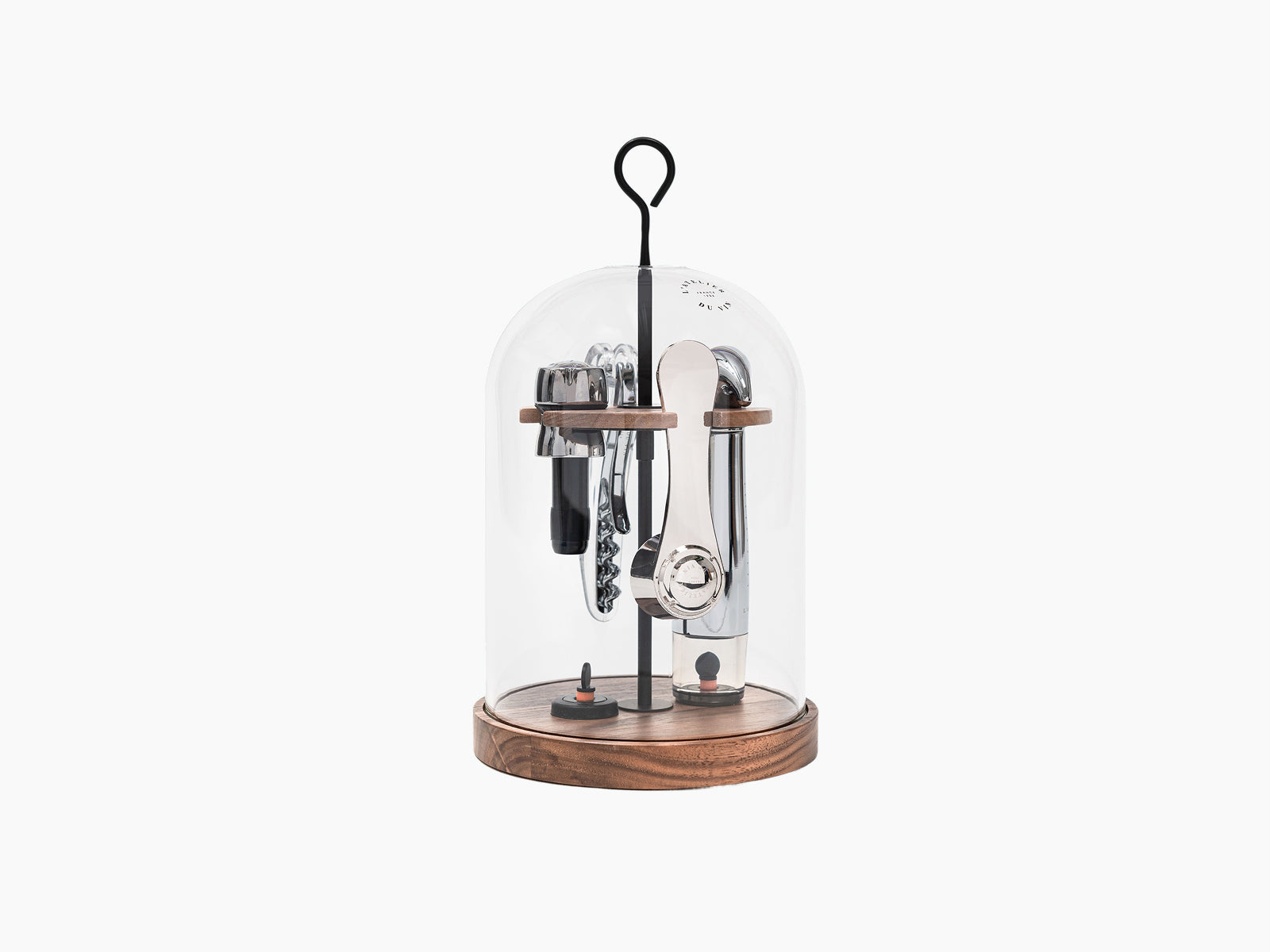 Le Globe glass dome wine tasting set resting on a walnut base with cork opener and other tools inside.