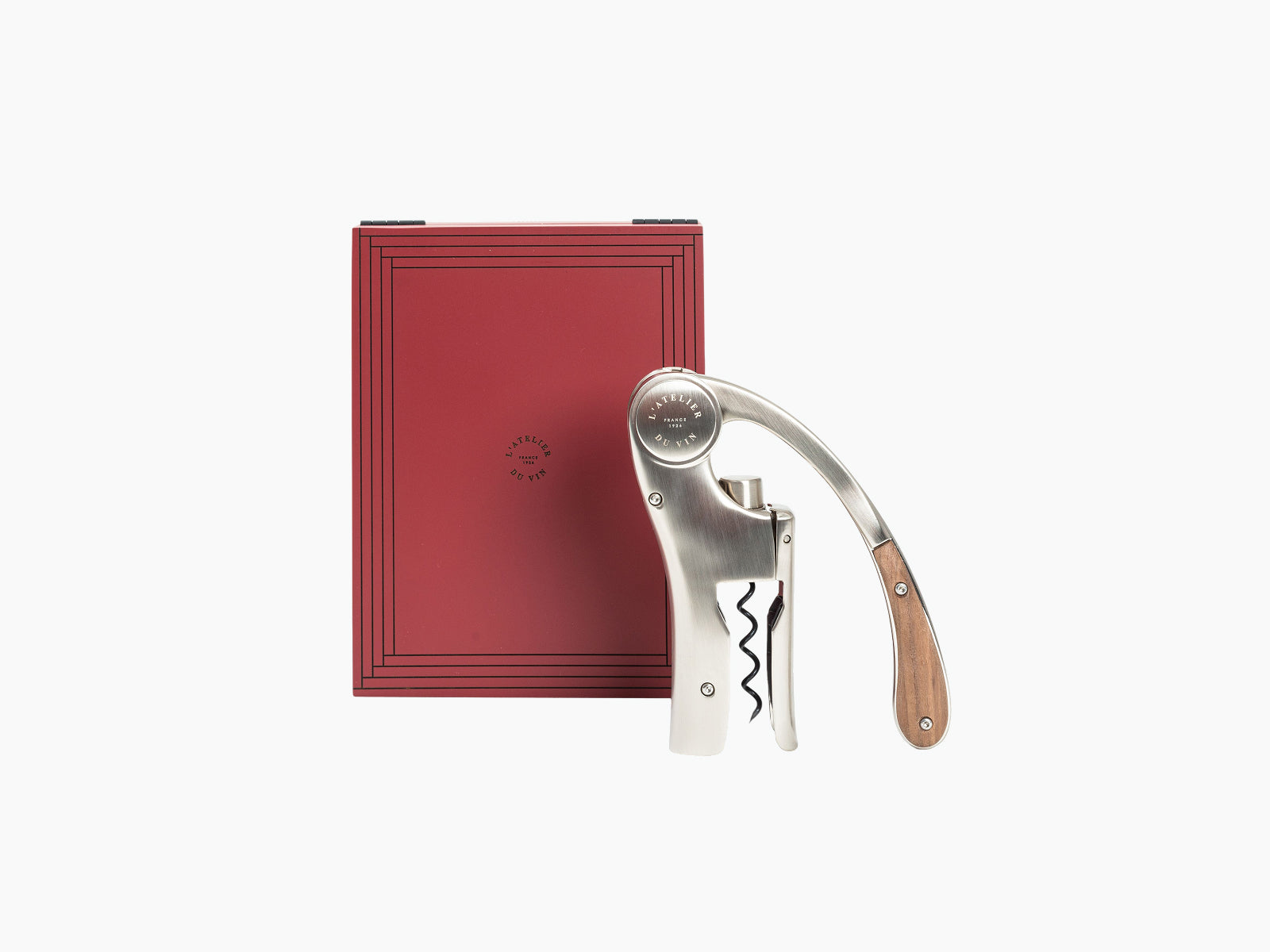 Red lacquered Oeno Motion Trésor box with a stainless steel lever corkscrew beside it.
